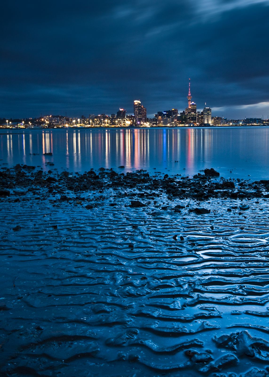 1143x1600 Auckland skyline from a beach in