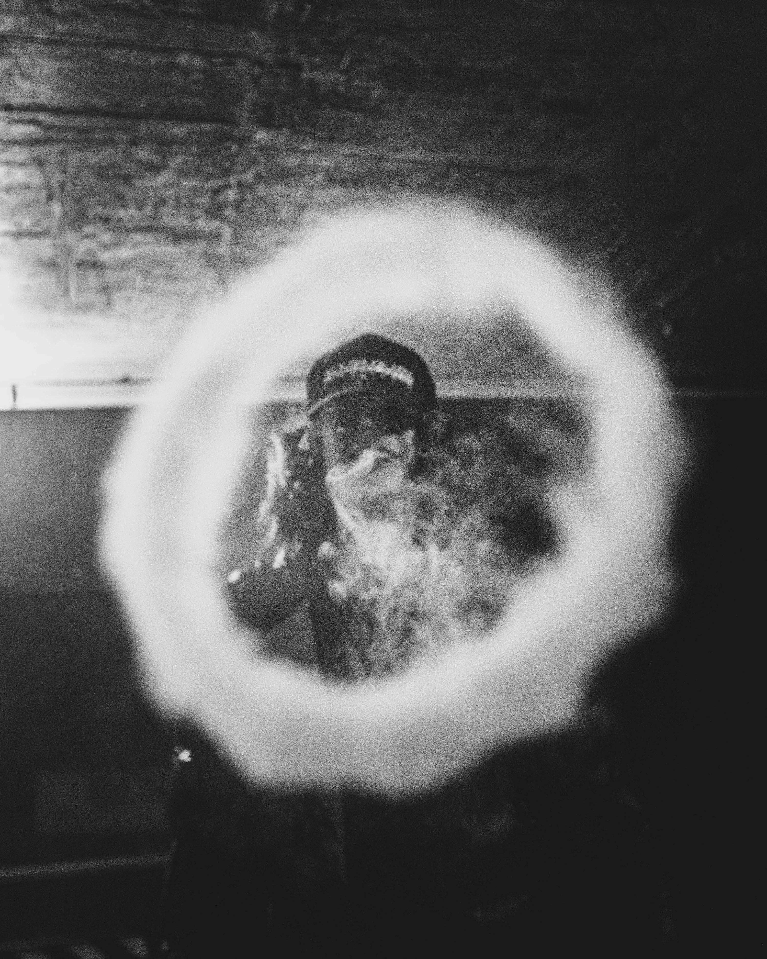 3000x3750 A person blows a smoke ring