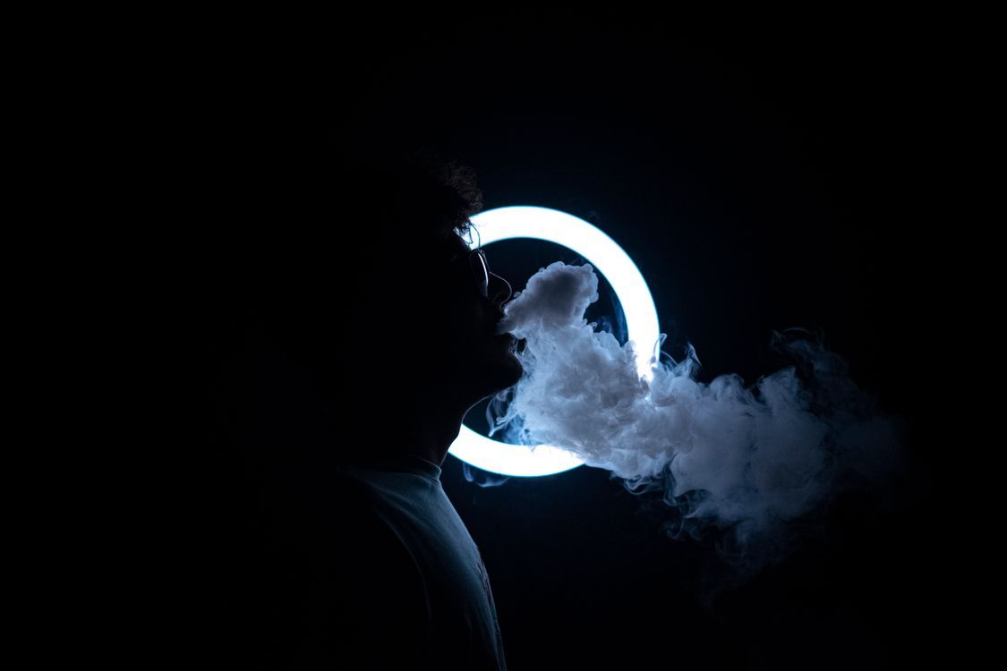 1125x750 A Man Smoking Near the Ring Light · Free