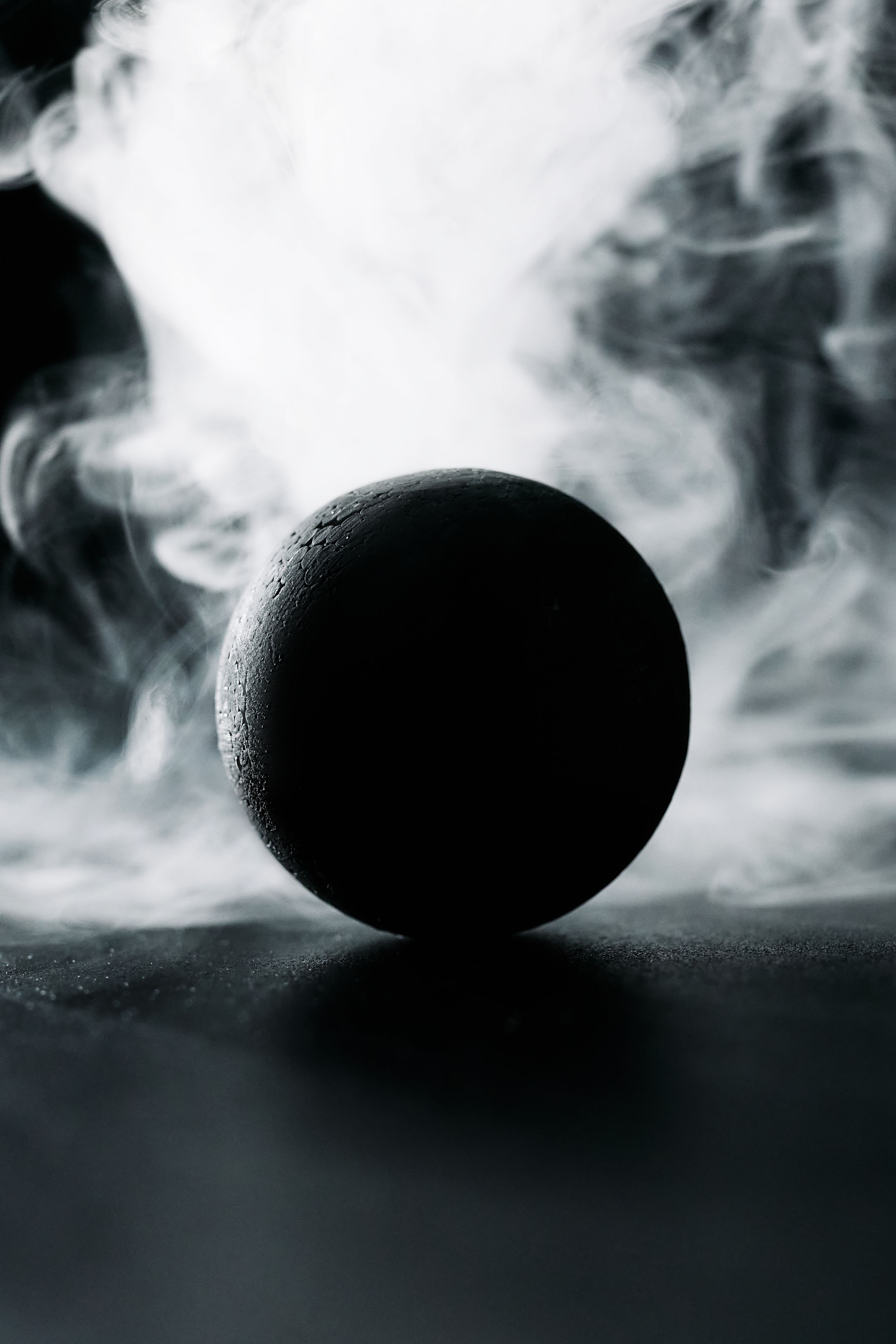 2971x4456 A Black Ball Against White Smoke · Free