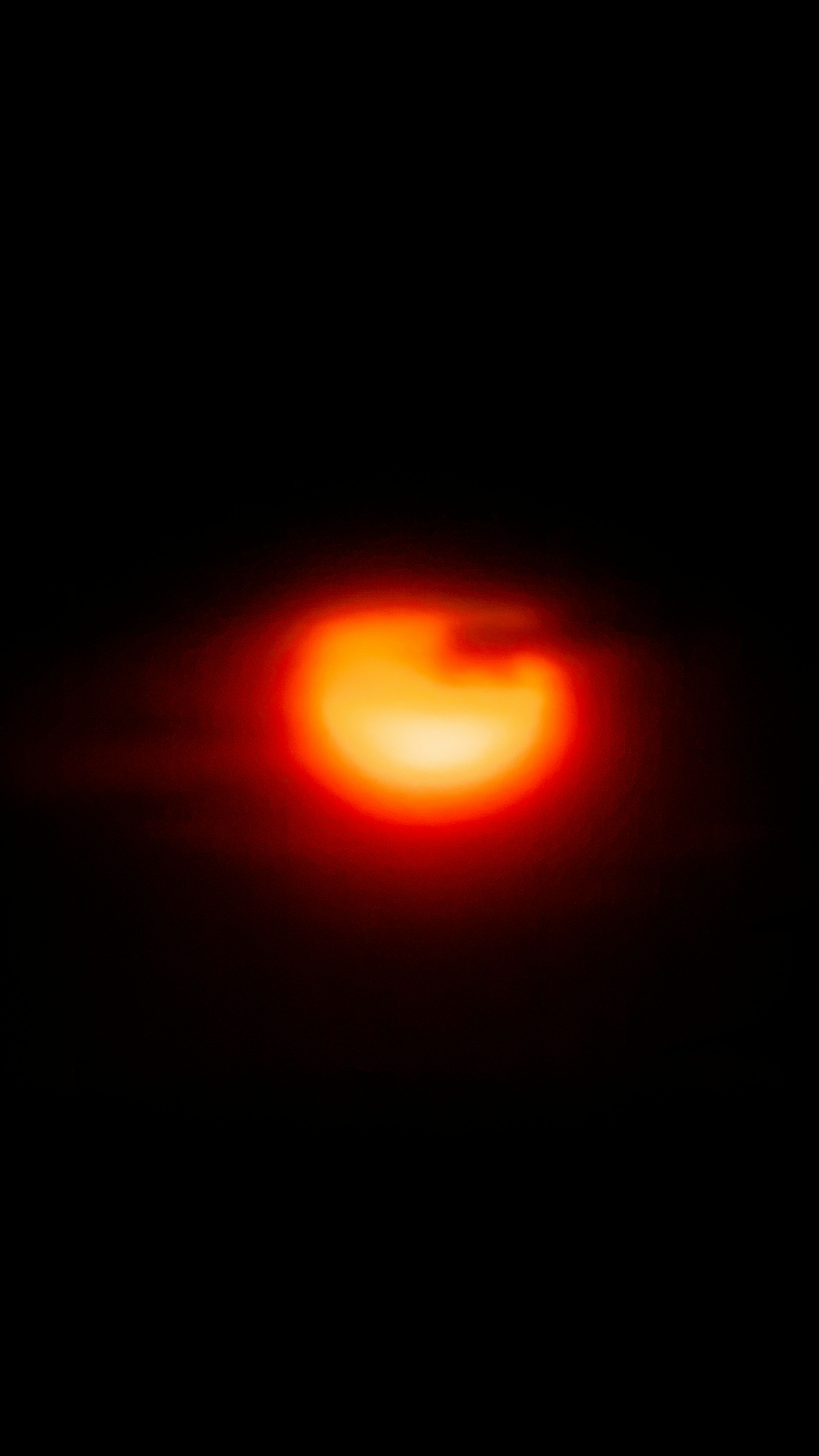 3000x5333 Glowing orange orb in night sky