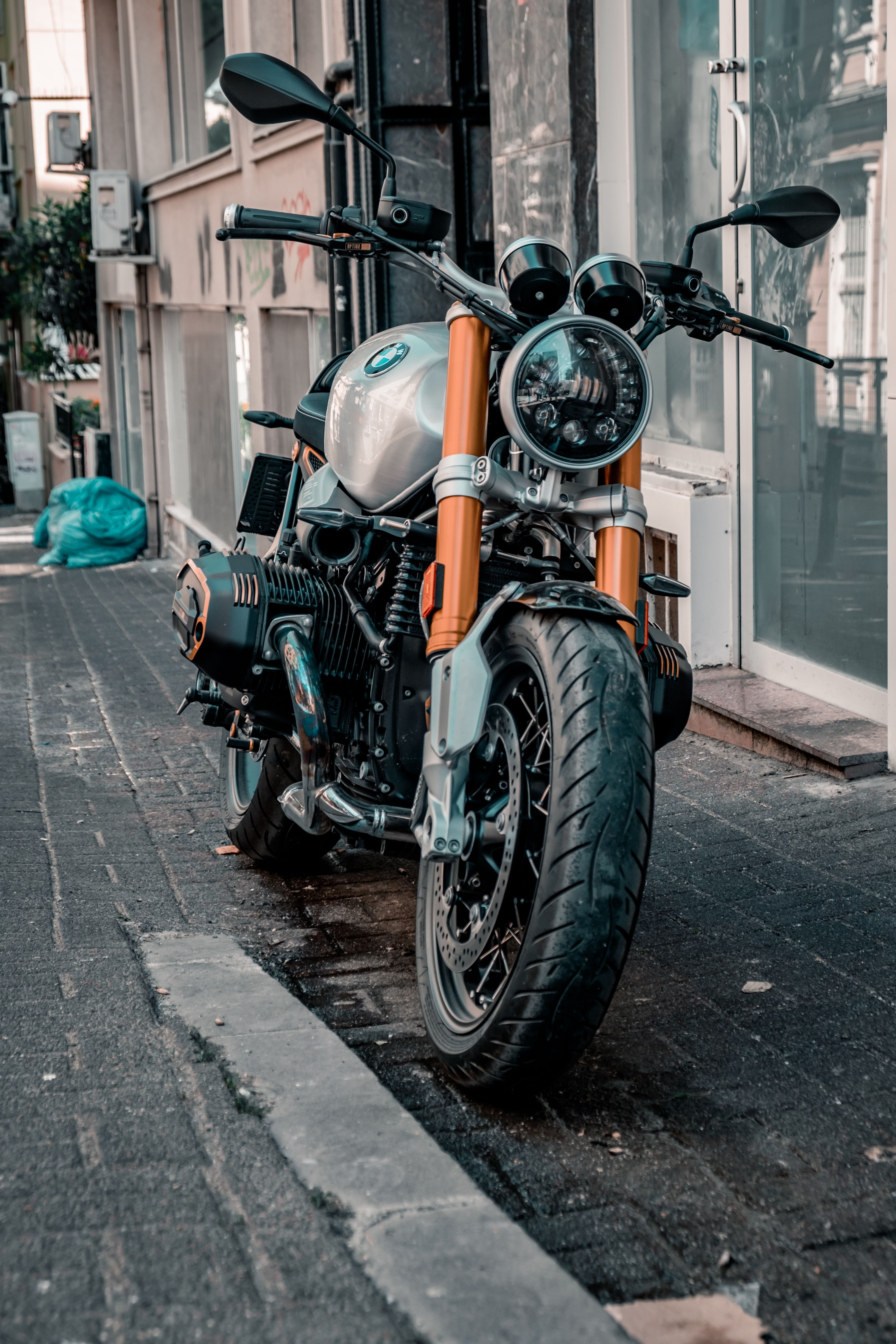 4160x6240 Black and Orange Motorcycle Parked Beside Gray Concrete Building · Free
