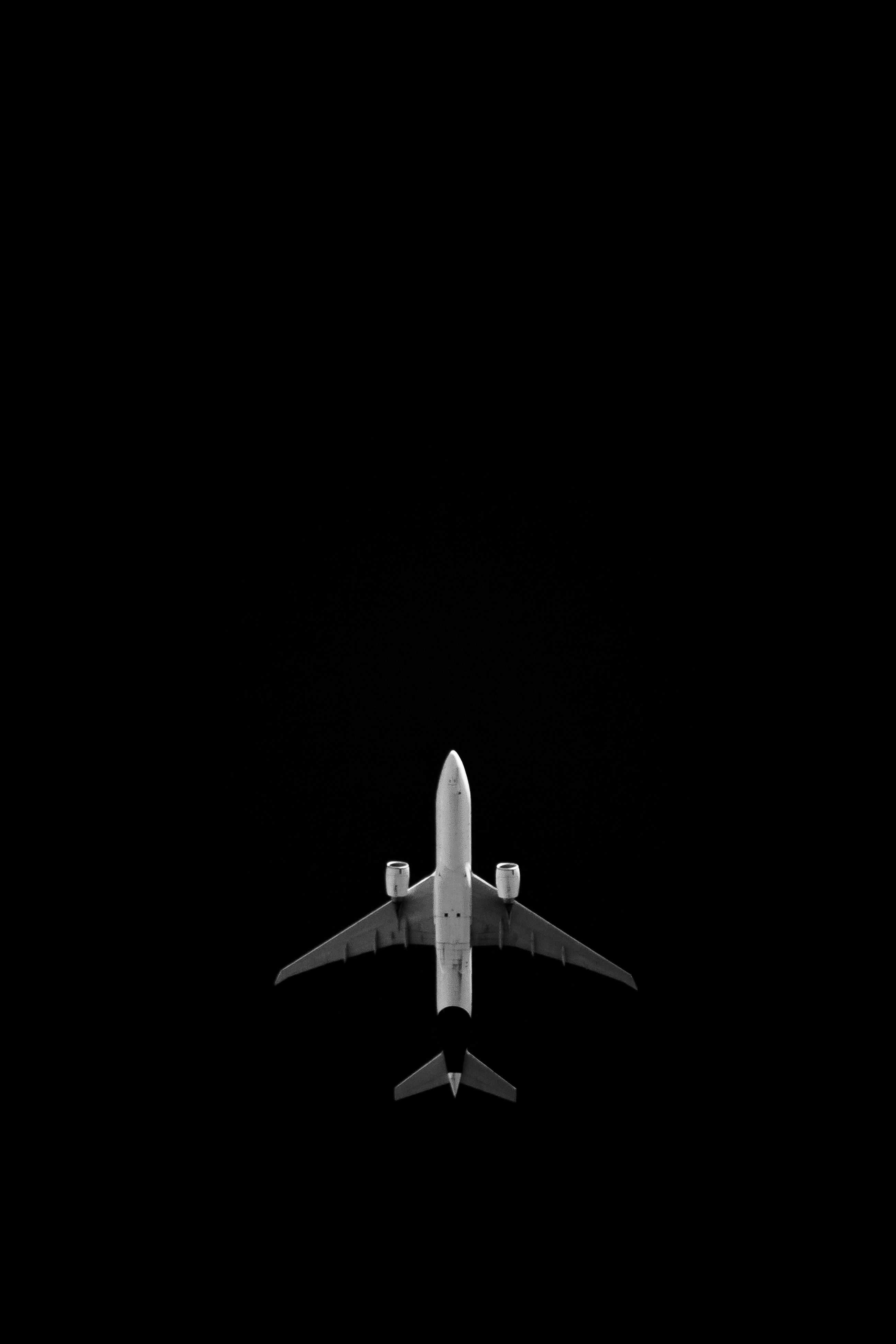 2609x3913 Low Angle Shot of a Flying Plane against the Night Sky · Free