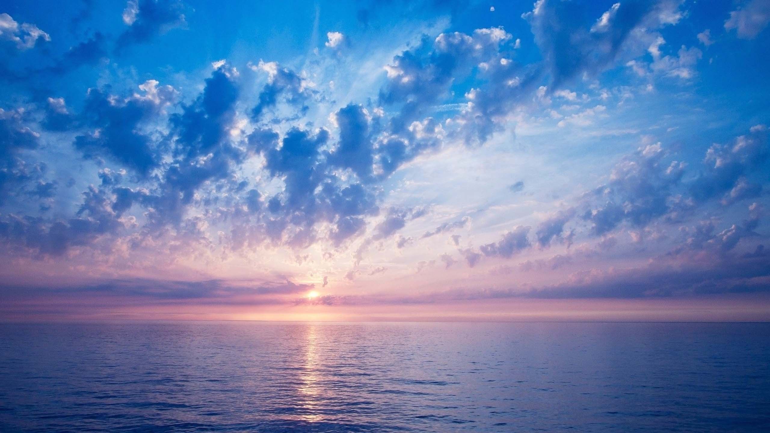 2560x1440 Sunrise Shadow On Beach Water Under Blue Cloudy Sky HD Sky Wallpaper