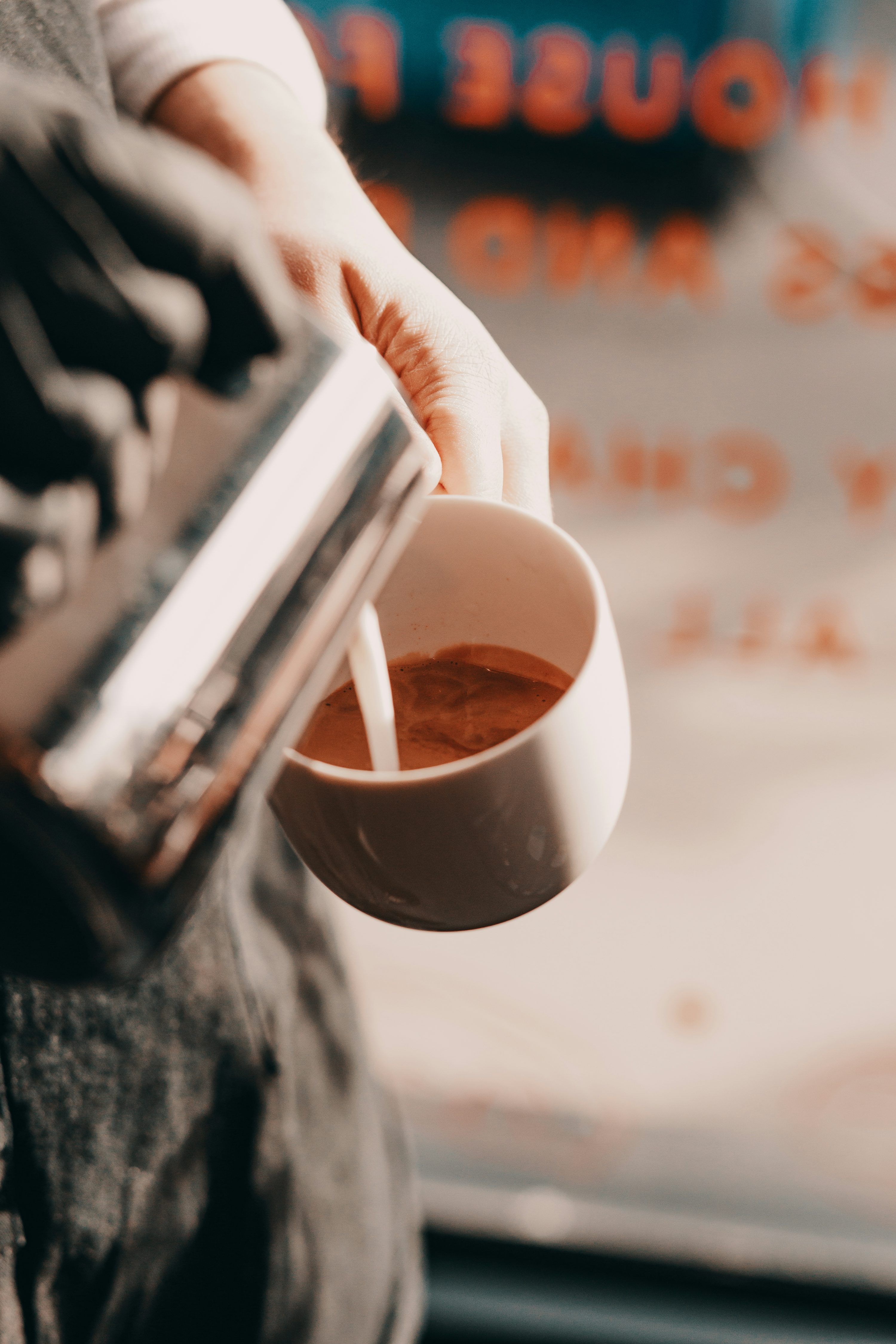 3000x4500 A person pouring a cup of coffee from a coffee maker