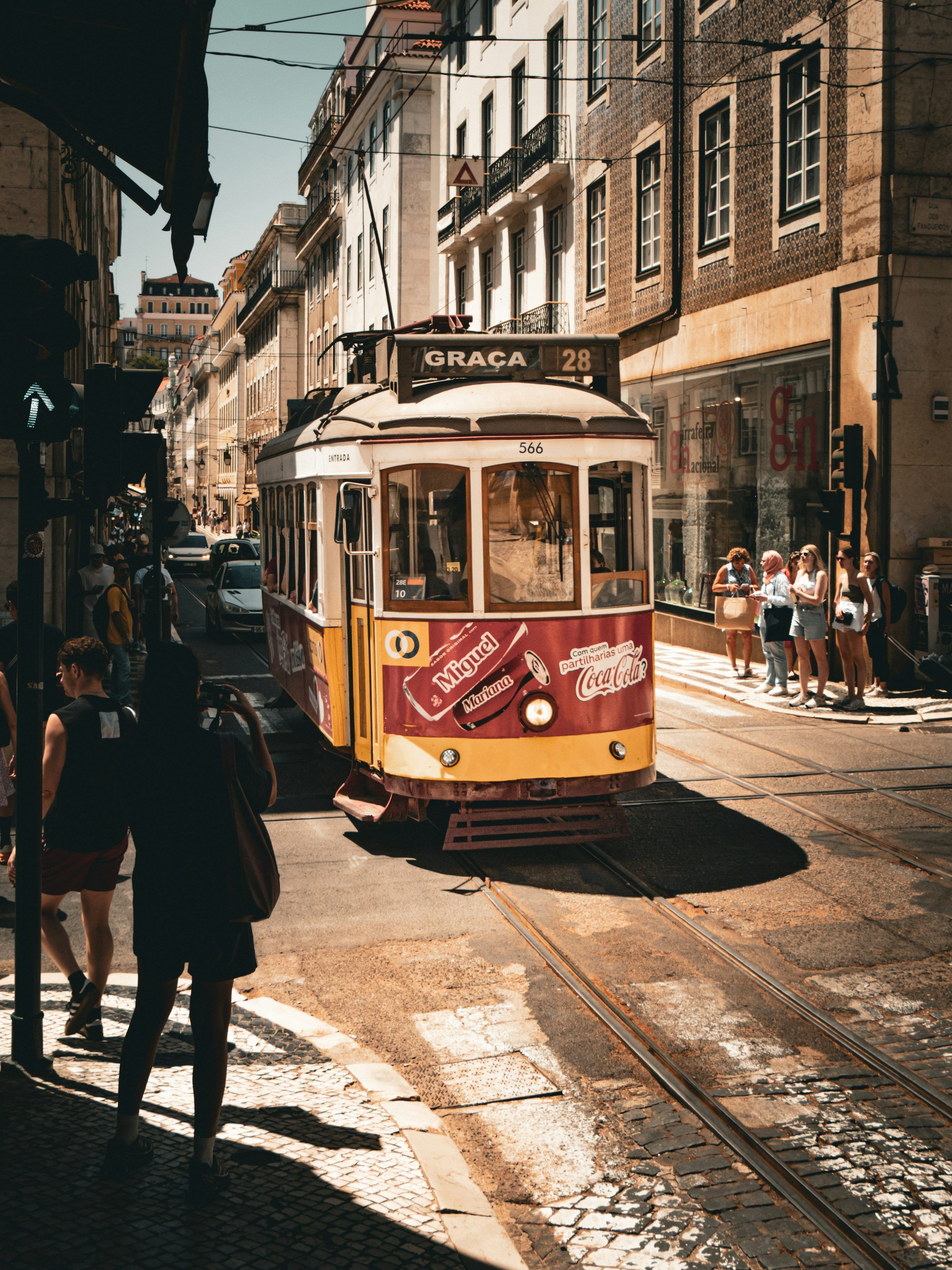 3000x4000 A vintage tram travels down a sunny, european street