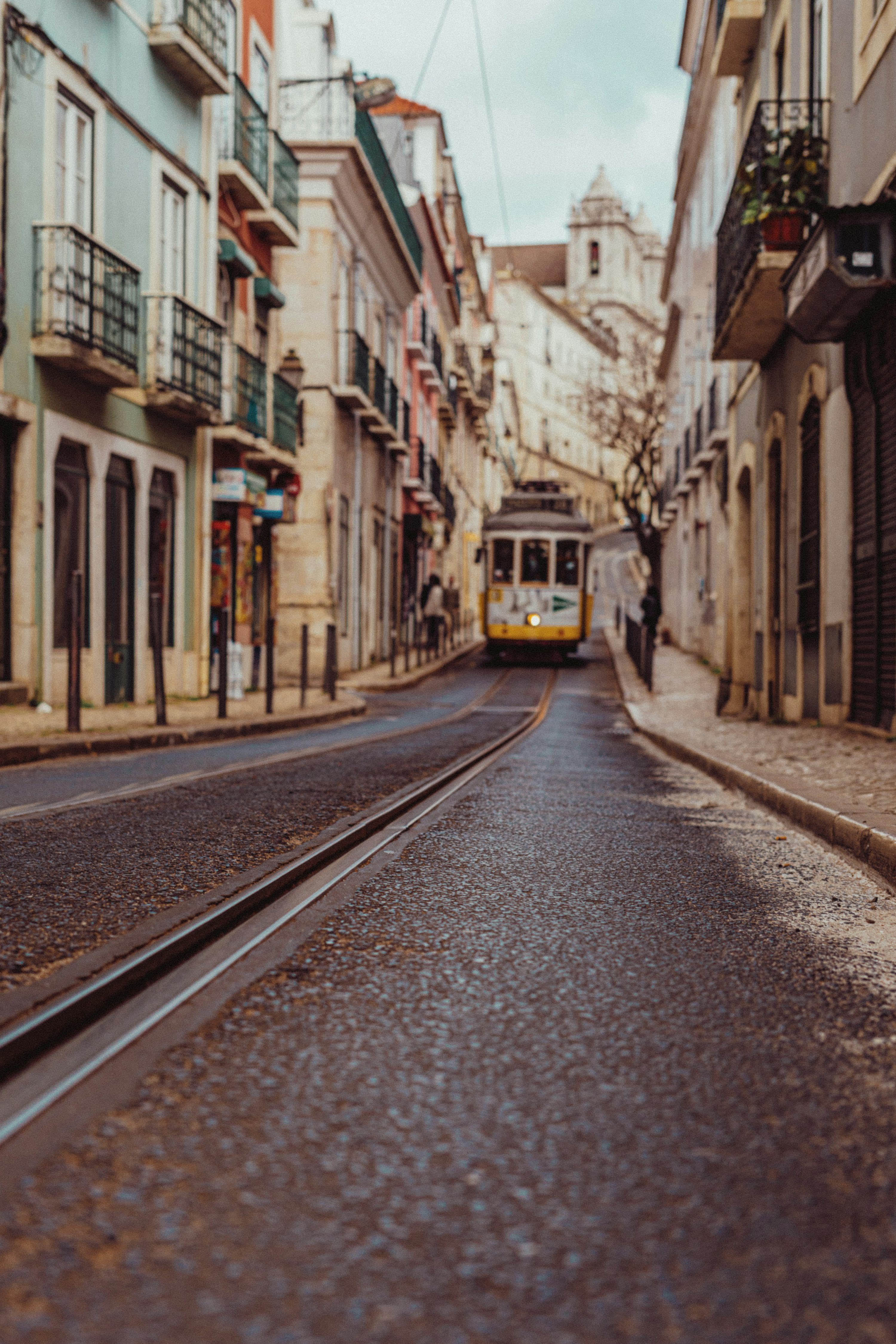 3000x4500 A yellow and white tram on a city street