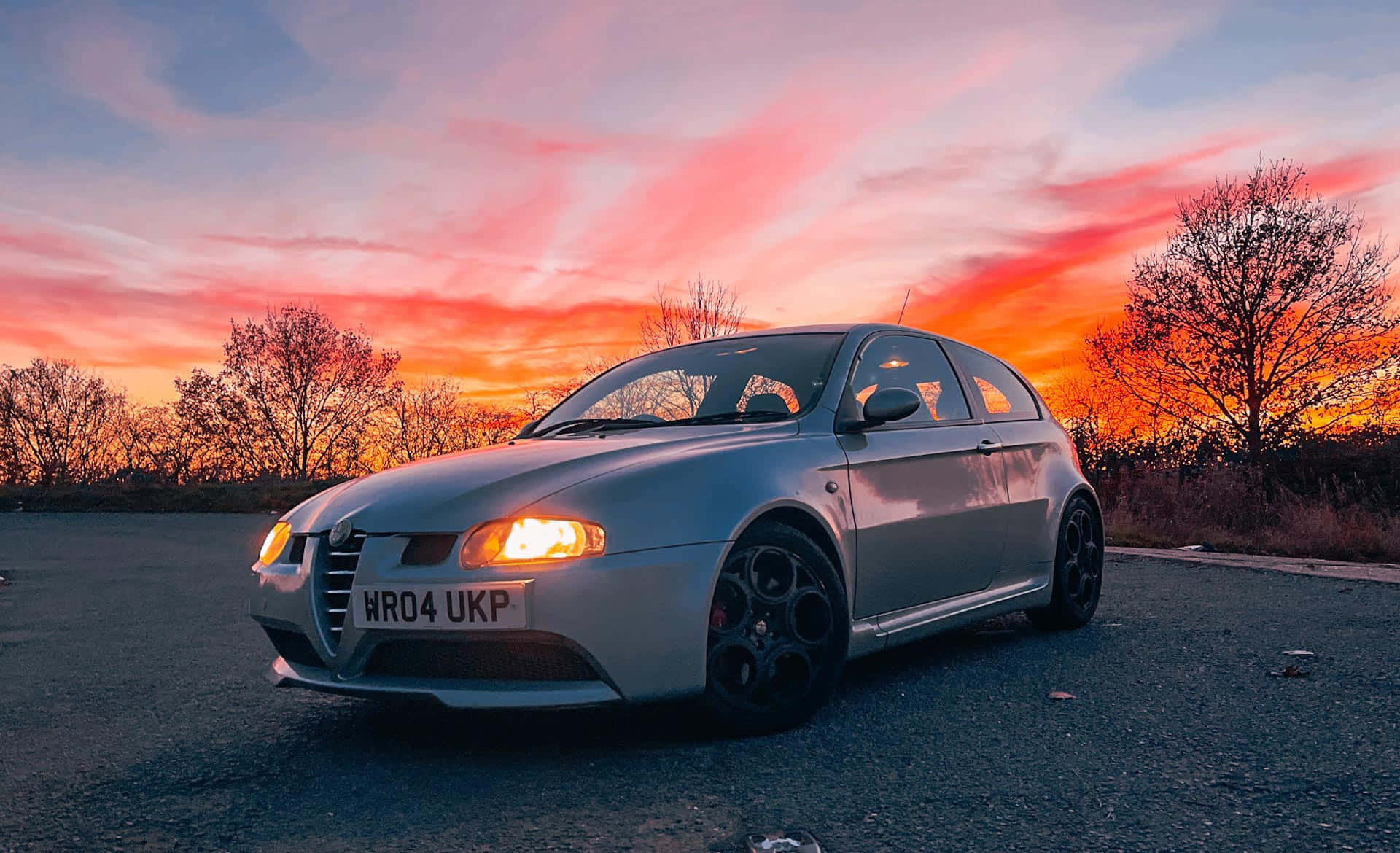 1920x1170 Download Sleek and Stylish Alfa Romeo 147 on a Scenic Road Wallpaper