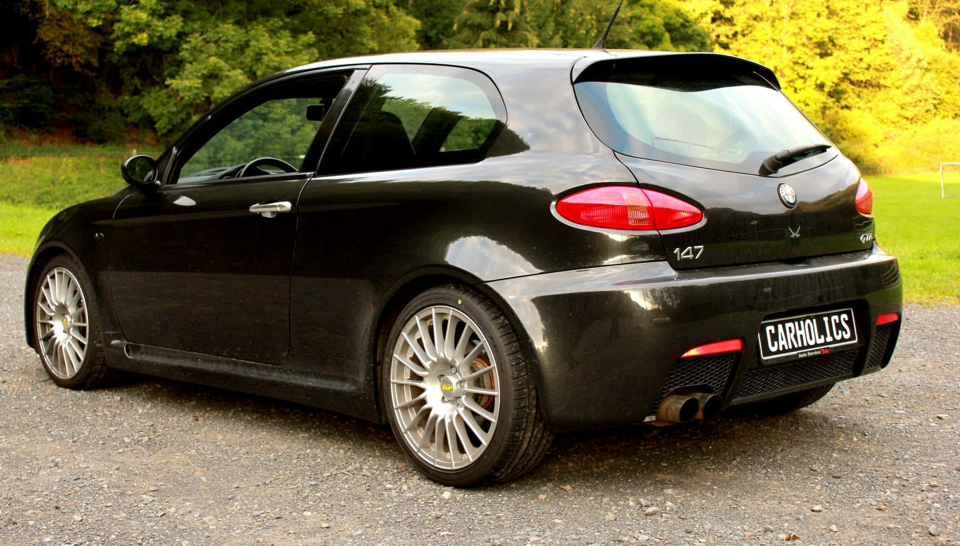 1940x1103 Download Sleek Alfa Romeo 147 on a Scenic Road Wallpaper