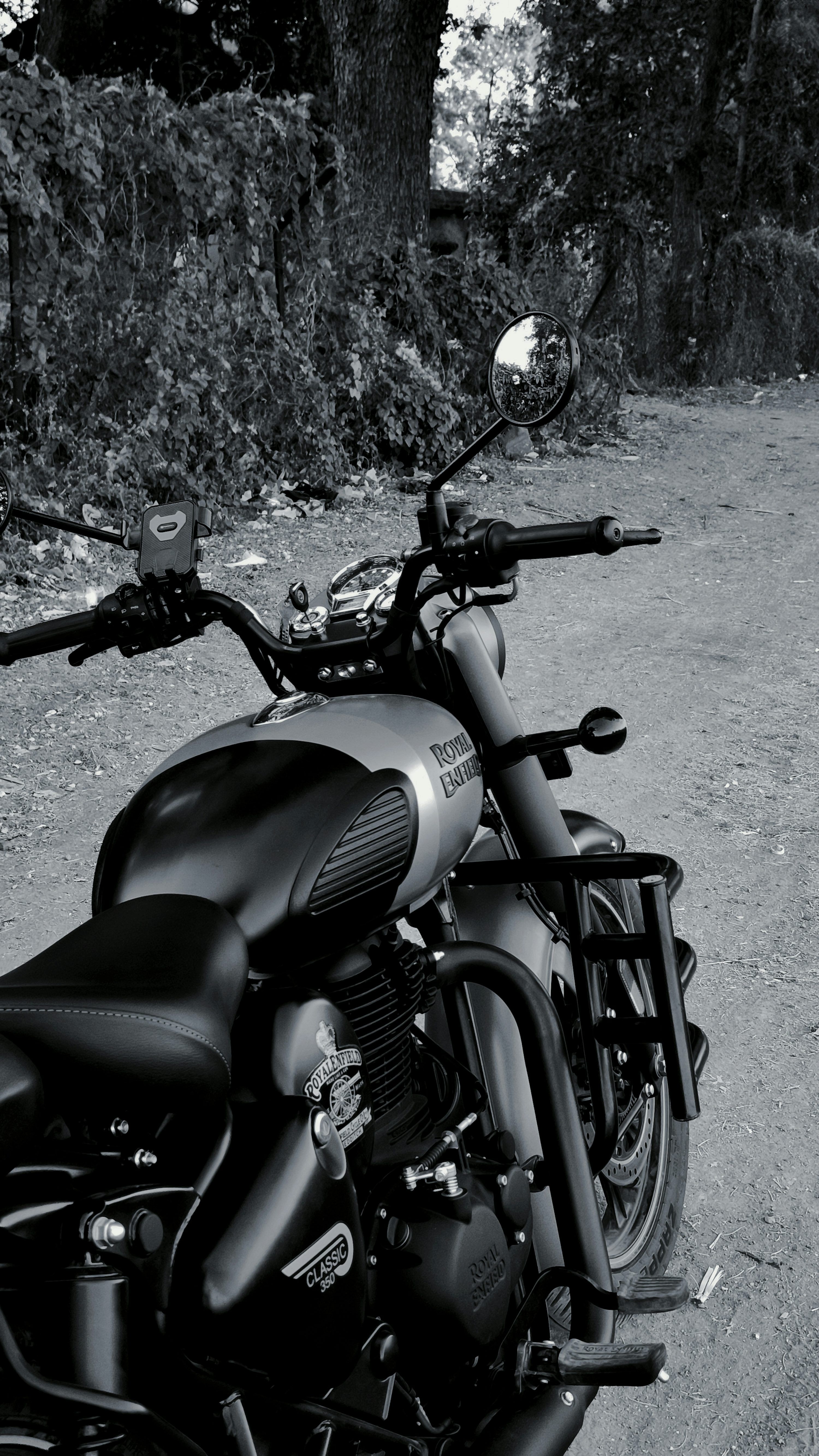 3000x5331 A black and white royal enfield motorcycle parked outdoors