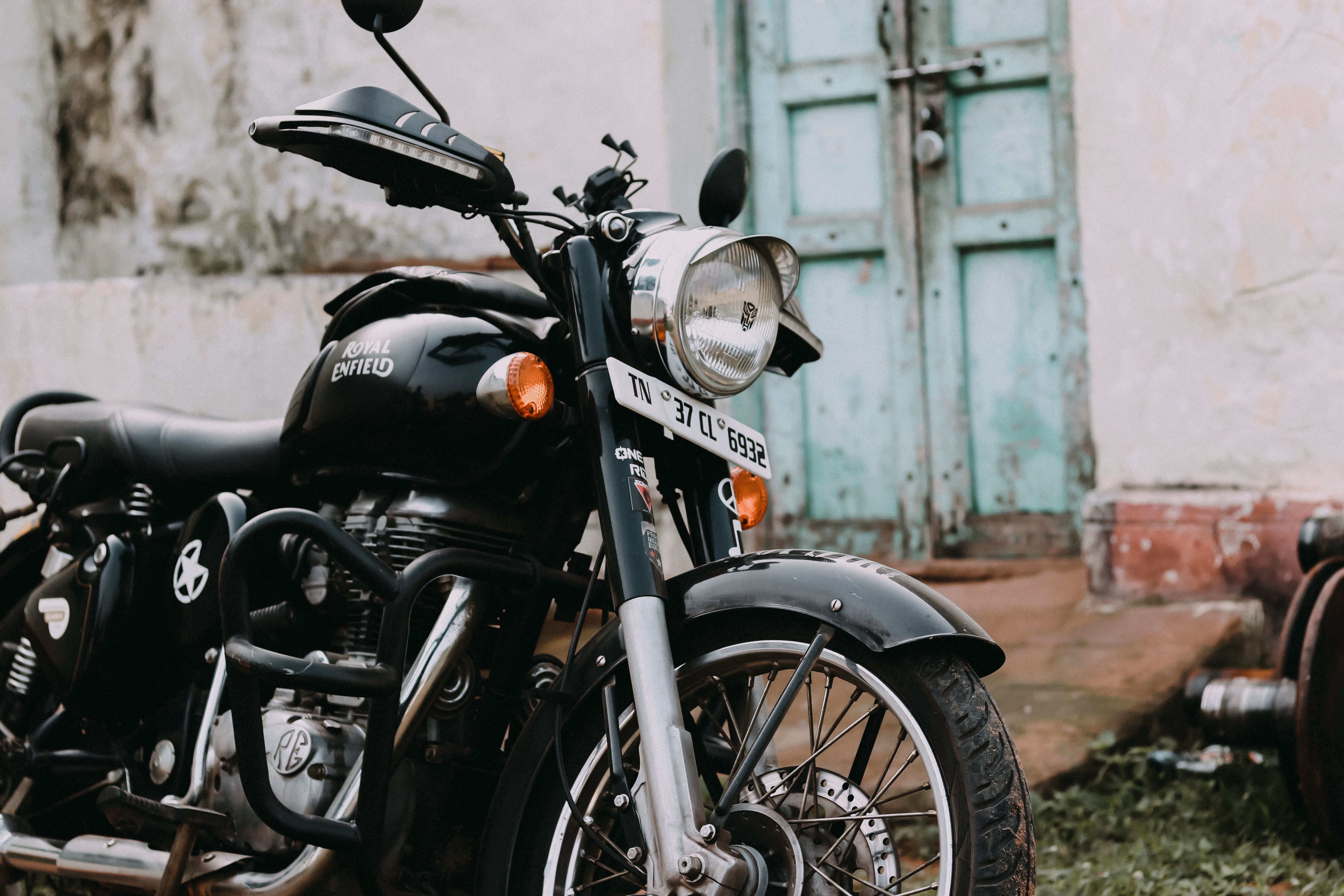 6000x4000 Black Royal Enfield Motorcycle Parked Near a House · Free