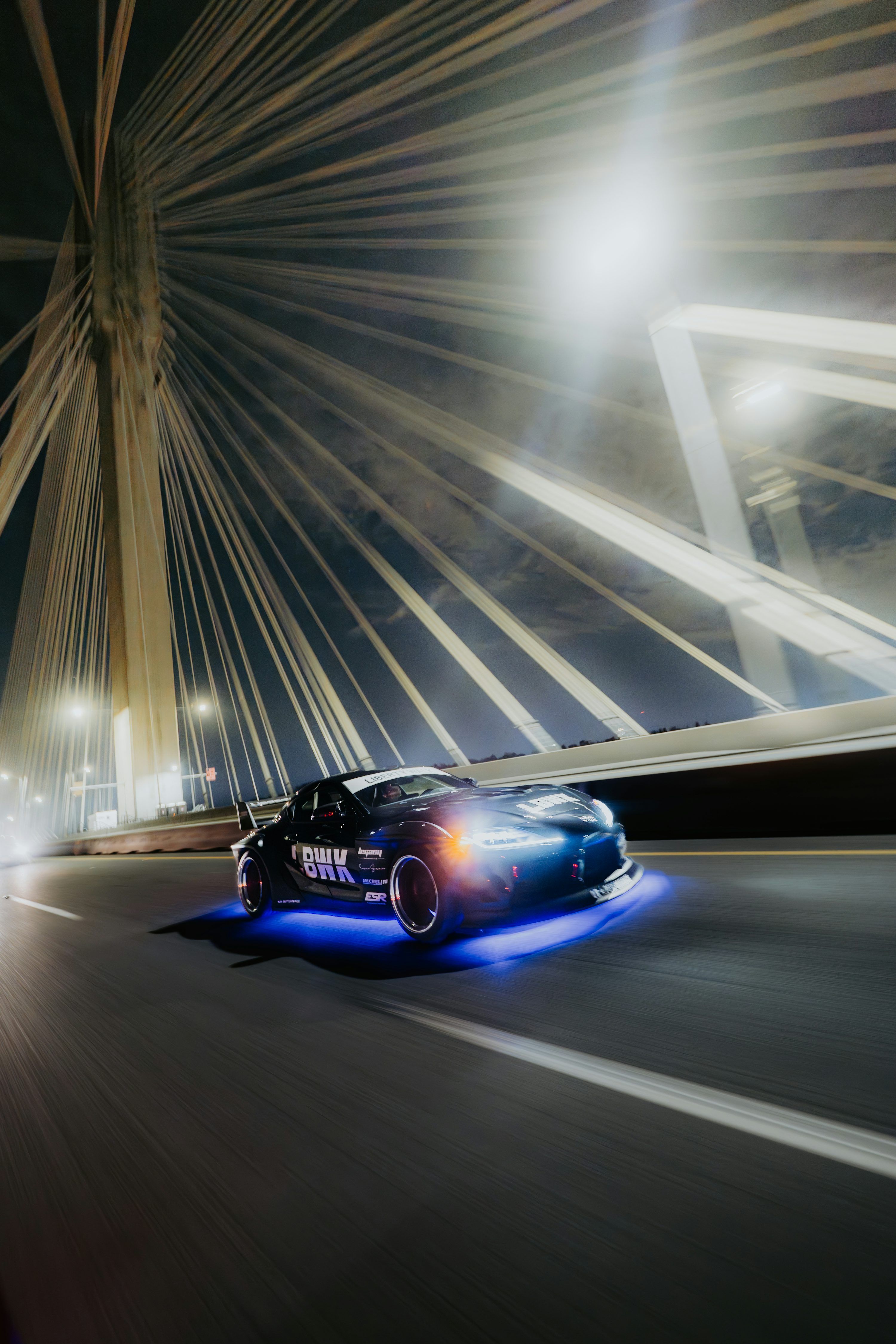 3000x4500 A Sports Car Drifts Under A Lit Up Bridge