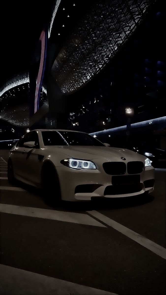 675x1200 White BMW 5 Series Luxury Car. Luxury car in urban night setting, Luxury car wallpaper ideas, Nighttime city driving inspiration