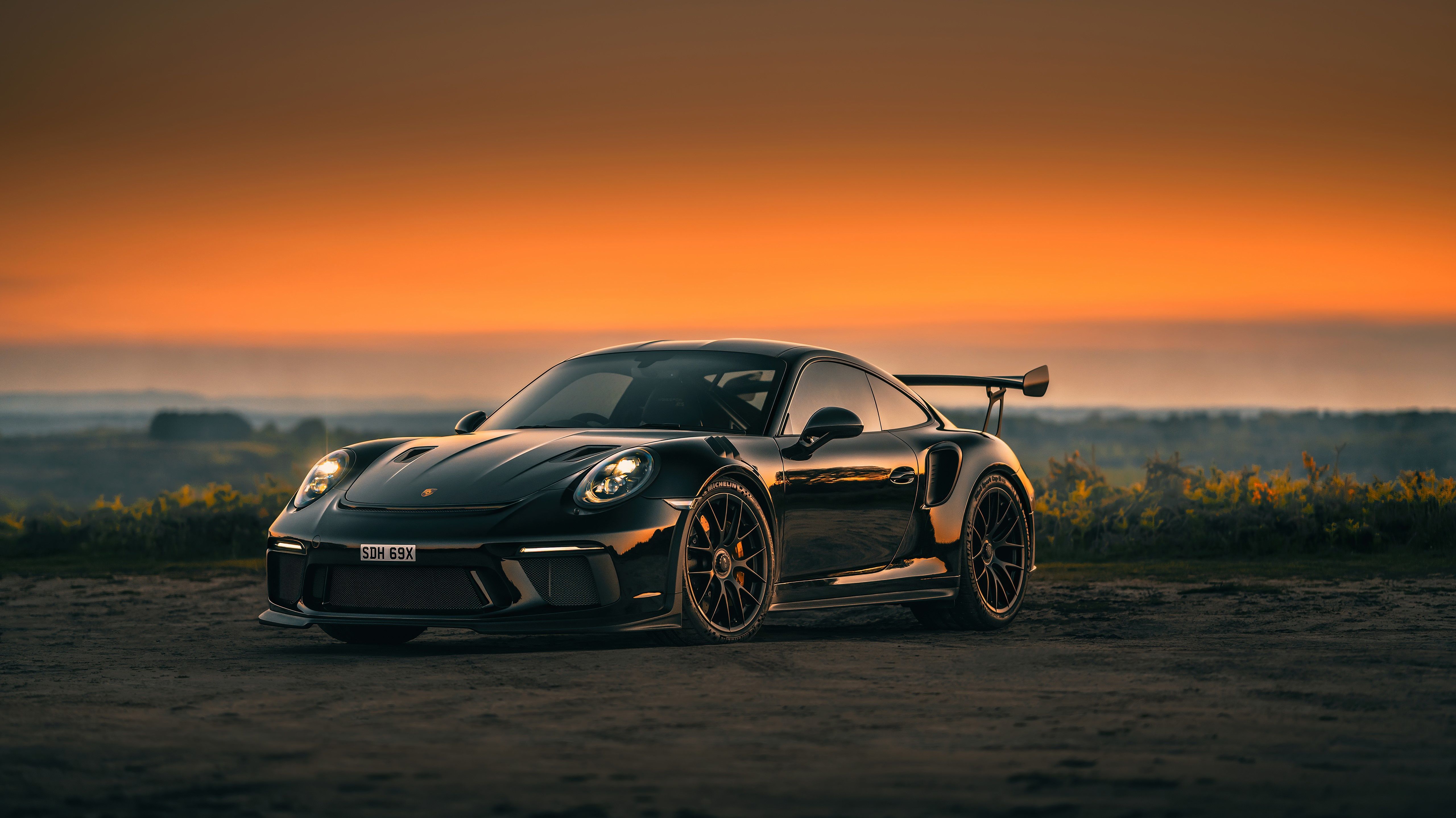 5120x2880 Sunset Embrace with a Black Porsche 911 GT3 Sports Car