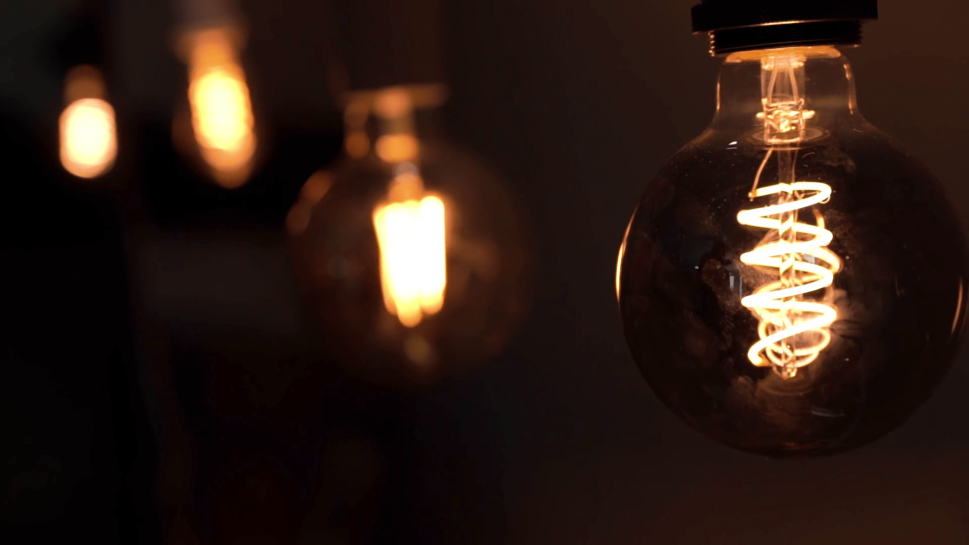 1920x1080 Tungsten light bulb lamps over black background. Concept of light and dark, idea, electricity at modern home