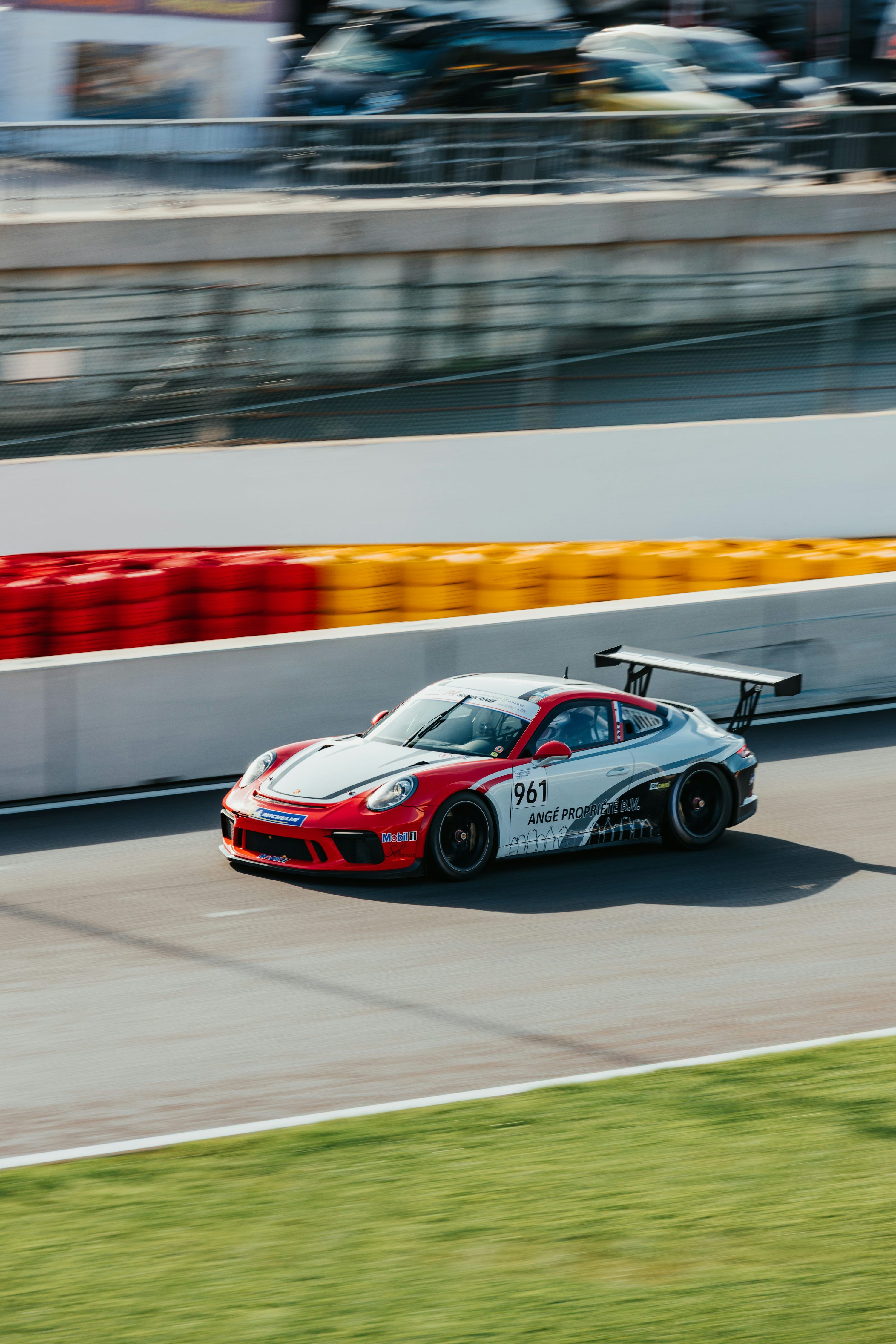 3000x4500 Race car speeds around a track with motion blur