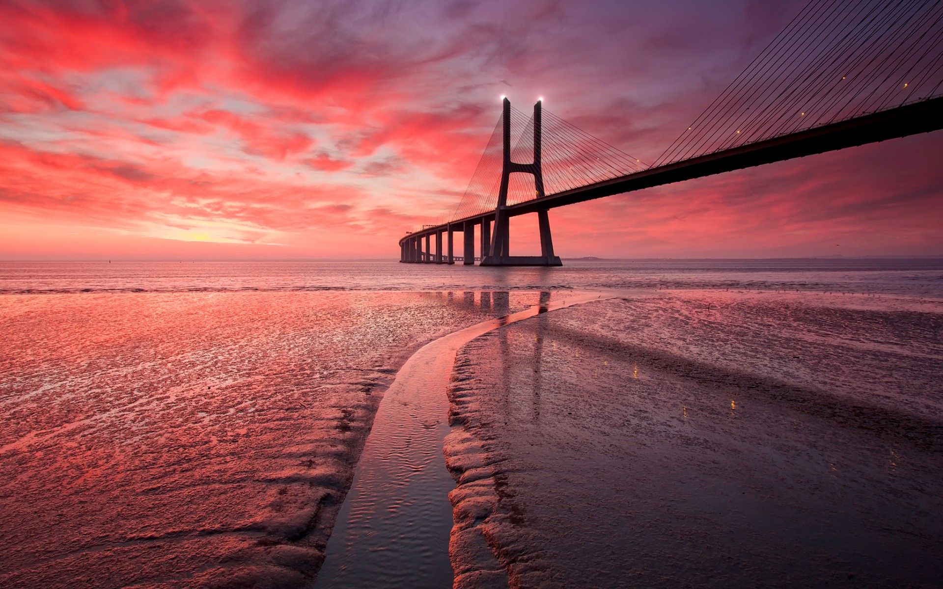 1920x1200 Vasco da Gama Bridge at Pink Sunset Over Portugal's Ocean Horizon