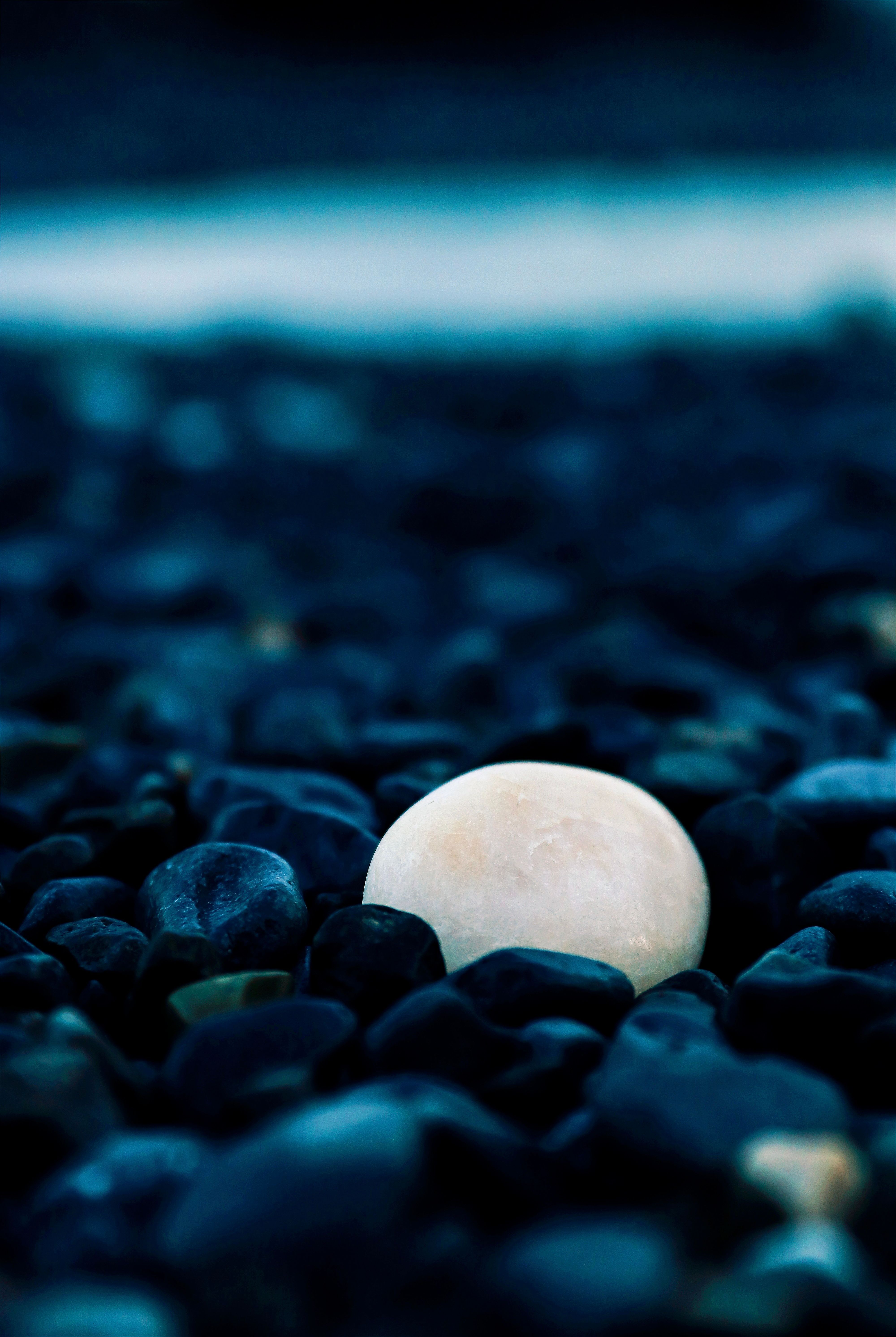4000x5968 White Stone among Pebbles · Free