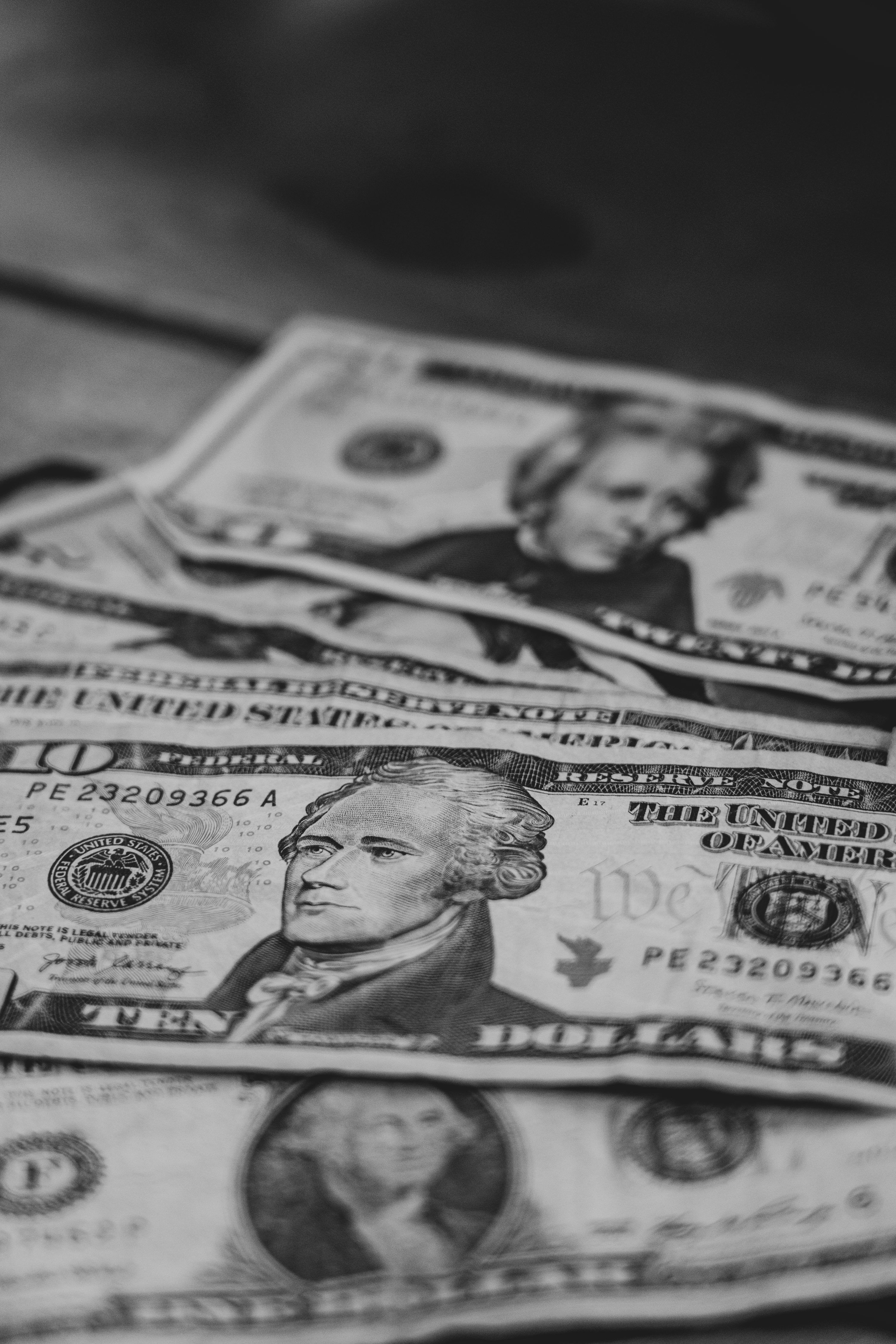 3000x4500 A pile of money sitting on top of a table