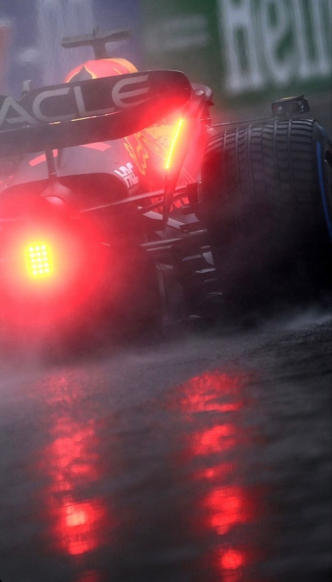 685x1200 Red Race Car Driving in the Rain. F1 race in rain, Motorsport photography tips, Red bull car wallpaper