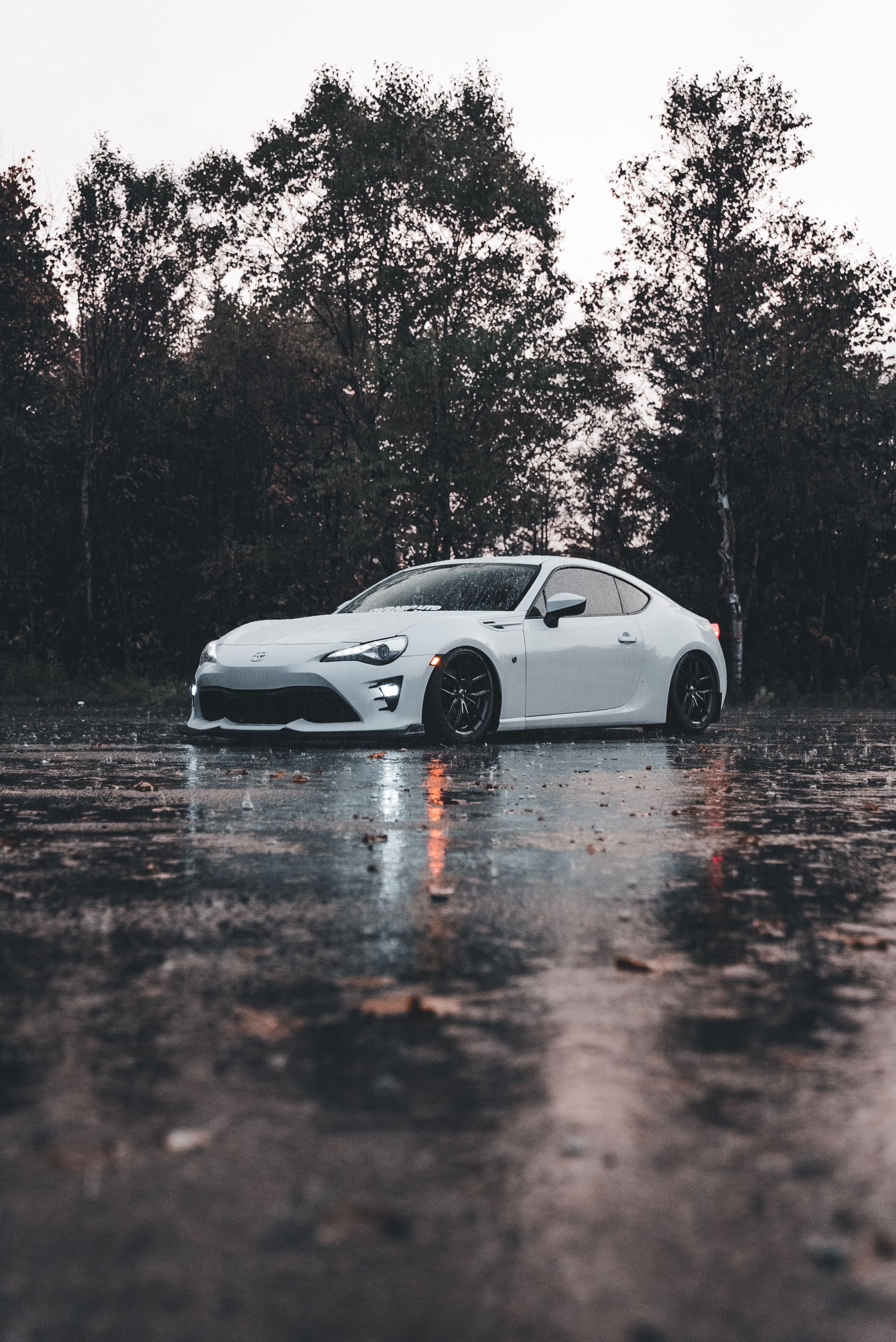 2786x4171 Sleek White Sports Car on a Rainy Day · Free