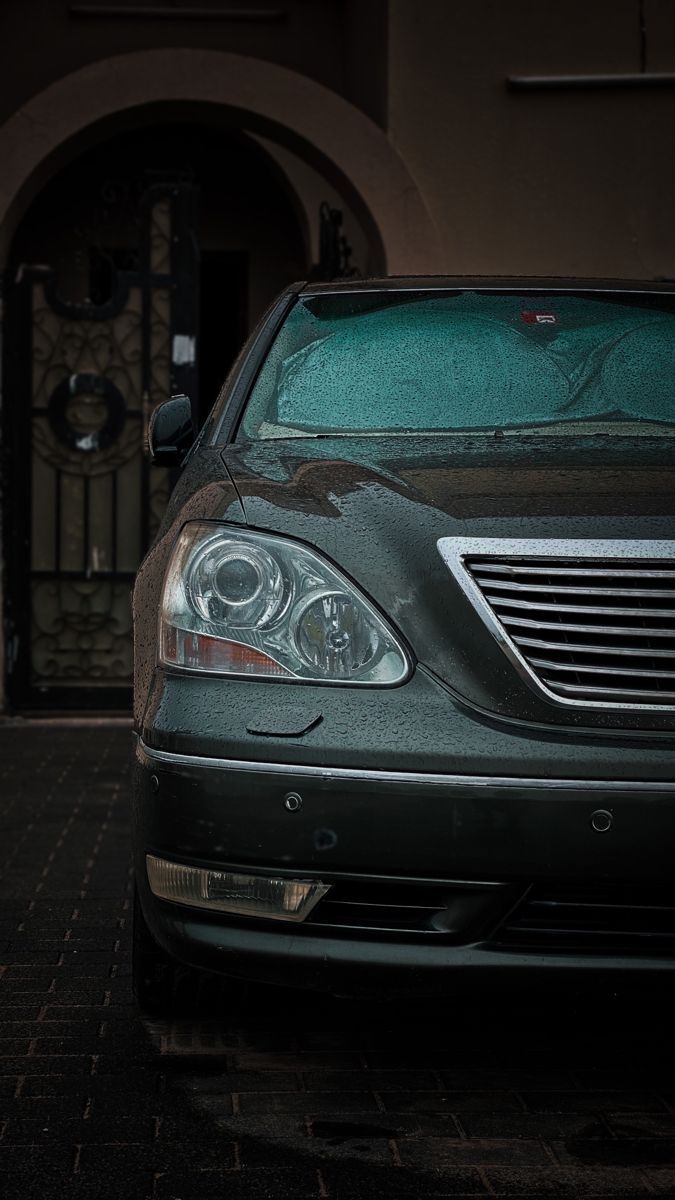 675x1200 Black Lexus parked in front of a building. Car photography tips, Green luxury car parked, Green sedan in driveway
