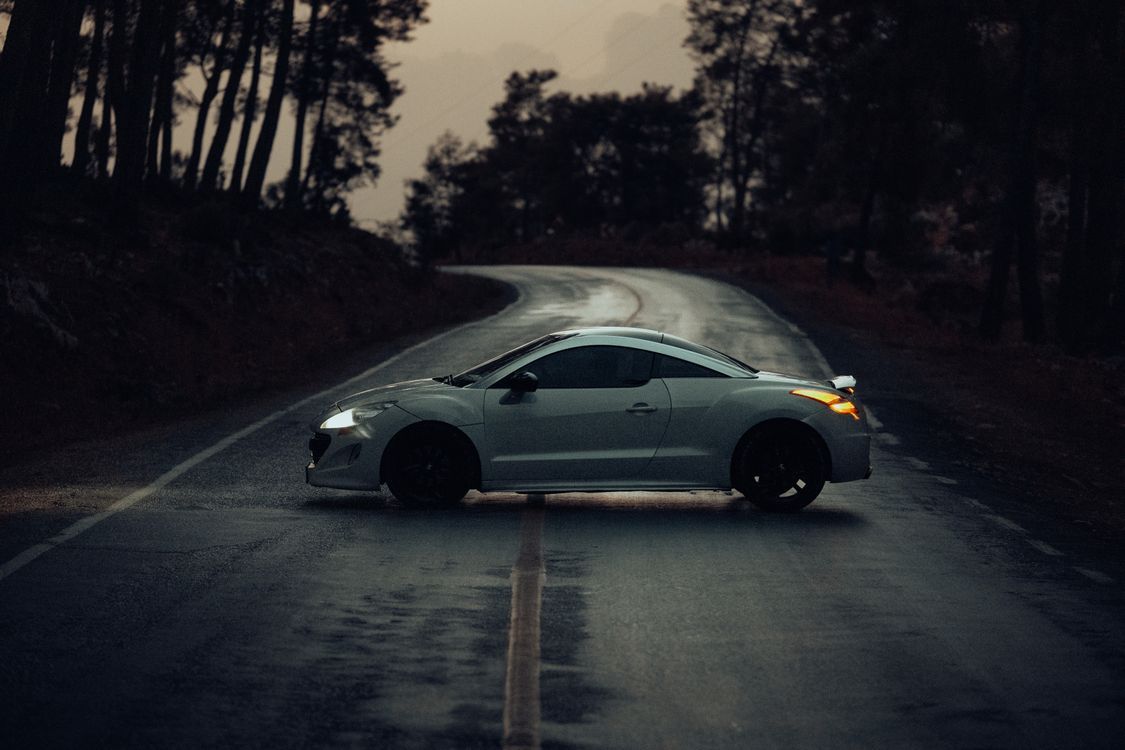 1125x750 Peugeot RCZ on Road in Forest in Evening · Free