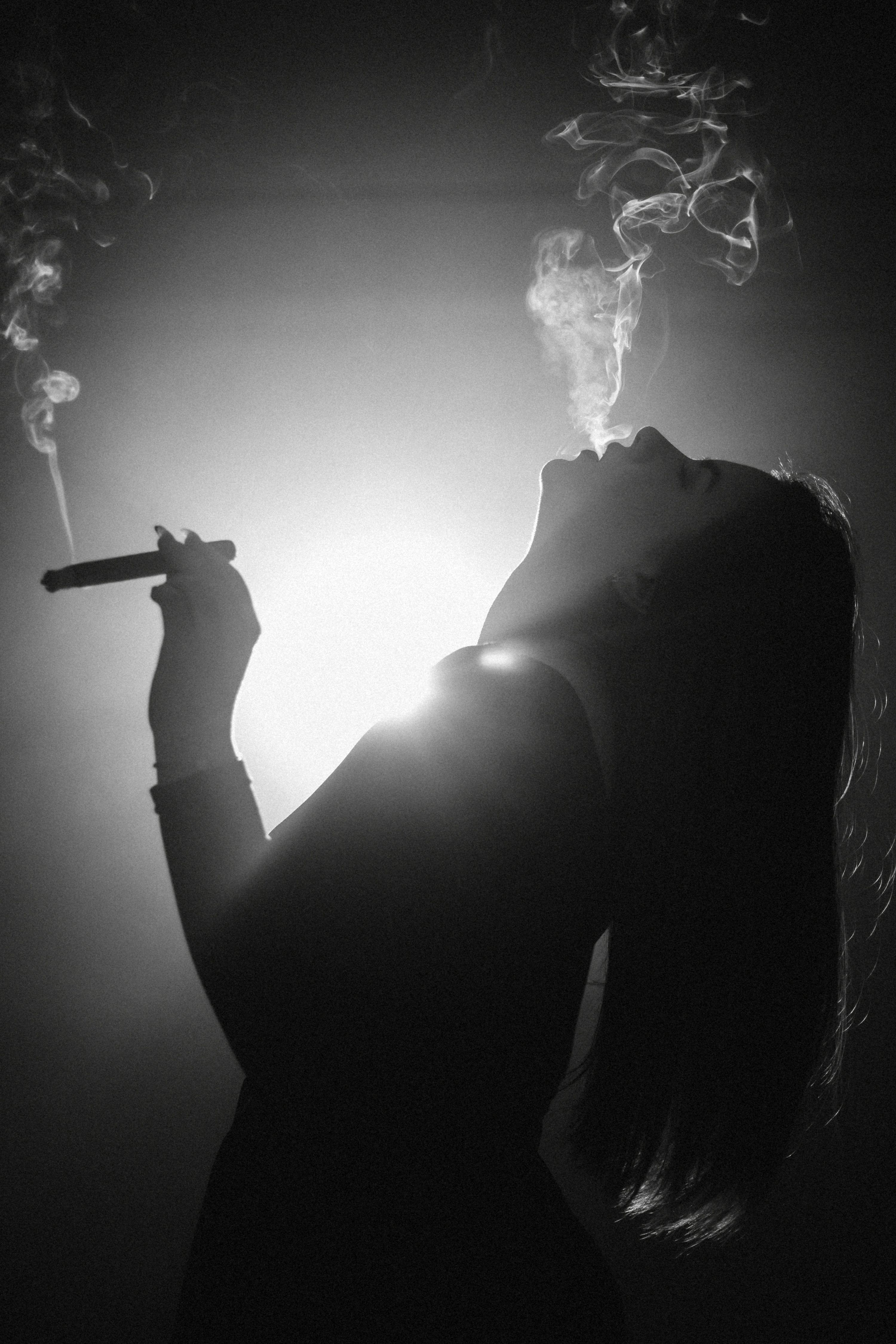 3000x4500 Silhouette of a woman smoking a cigar