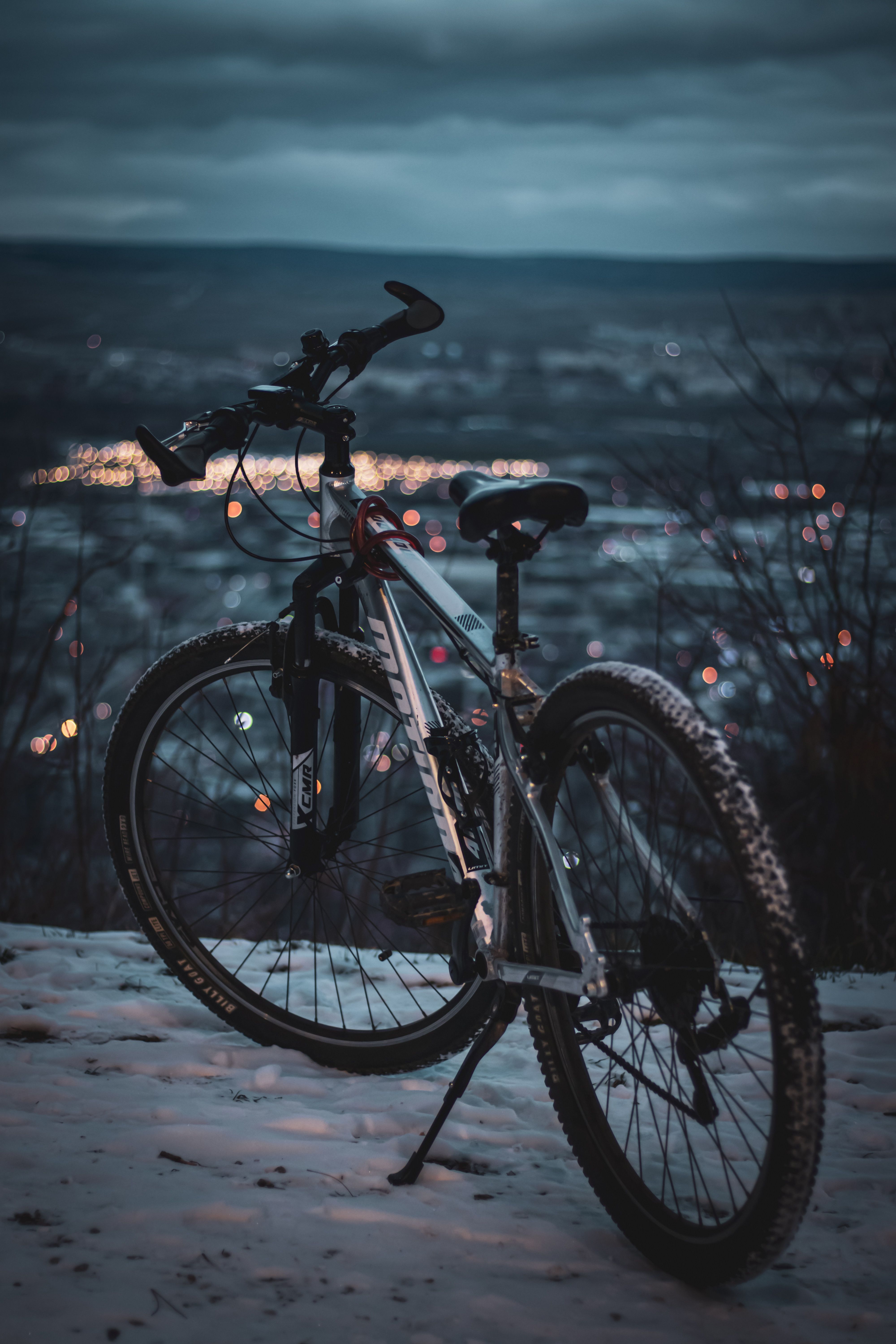 4000x6000 Mountain Bike Overlooking City Lights at Dusk · Free