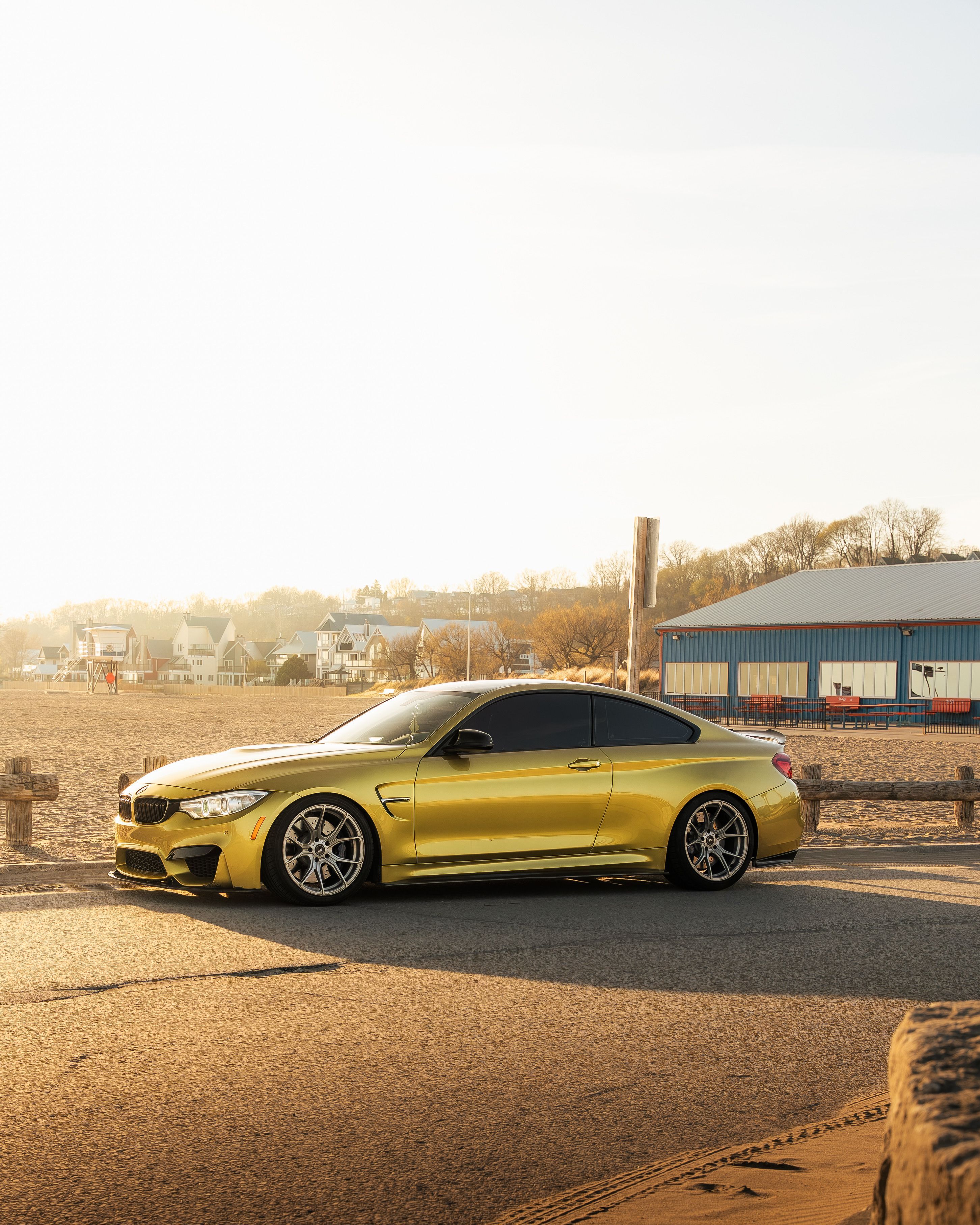 2904x3630 Sleek Gold Sports Car by the Beach at Sunset · Free