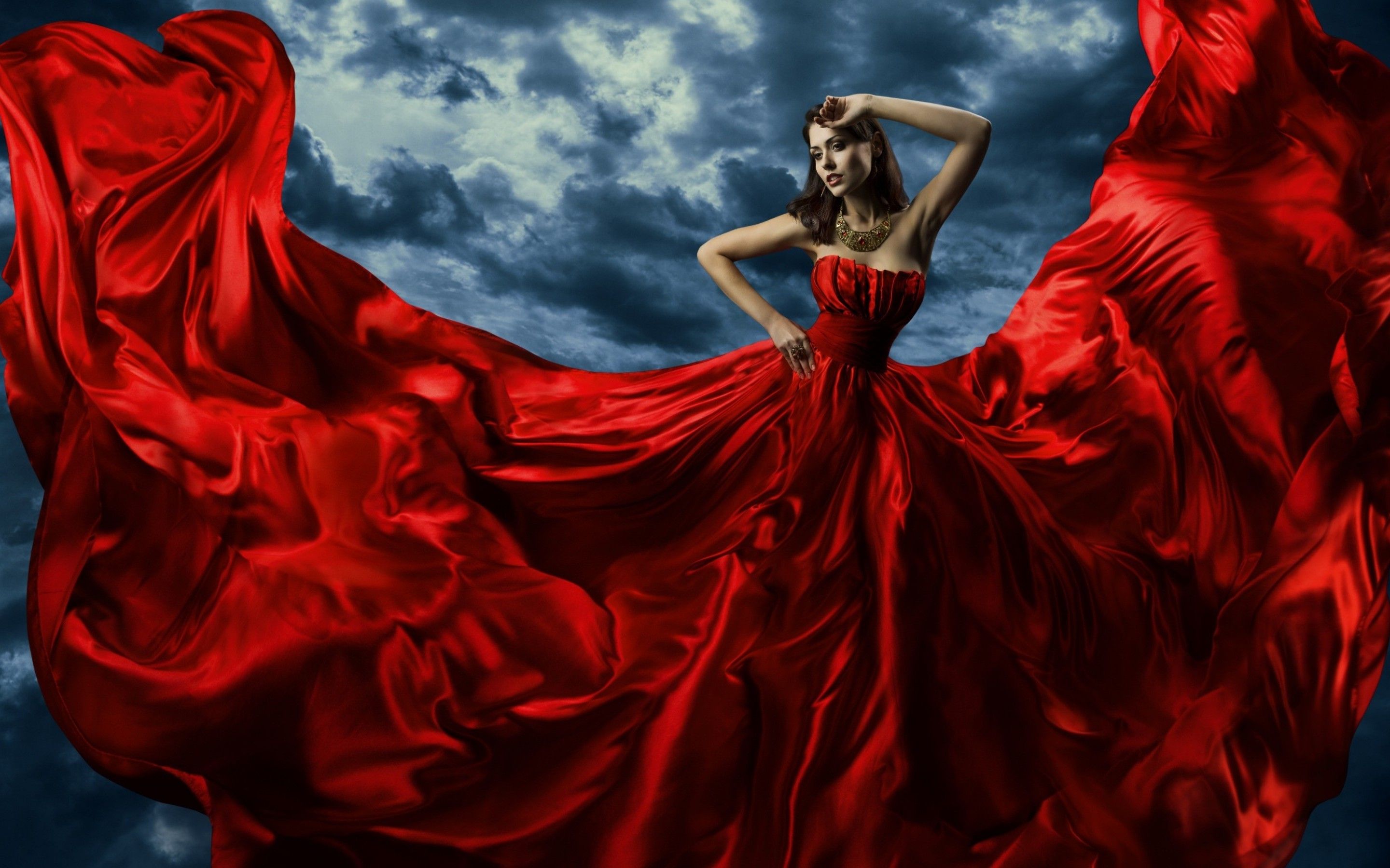 2880x1800 Elegance in Red: Artistic Woman Against Dramatic Cloudscape HD Wallpaperx1800