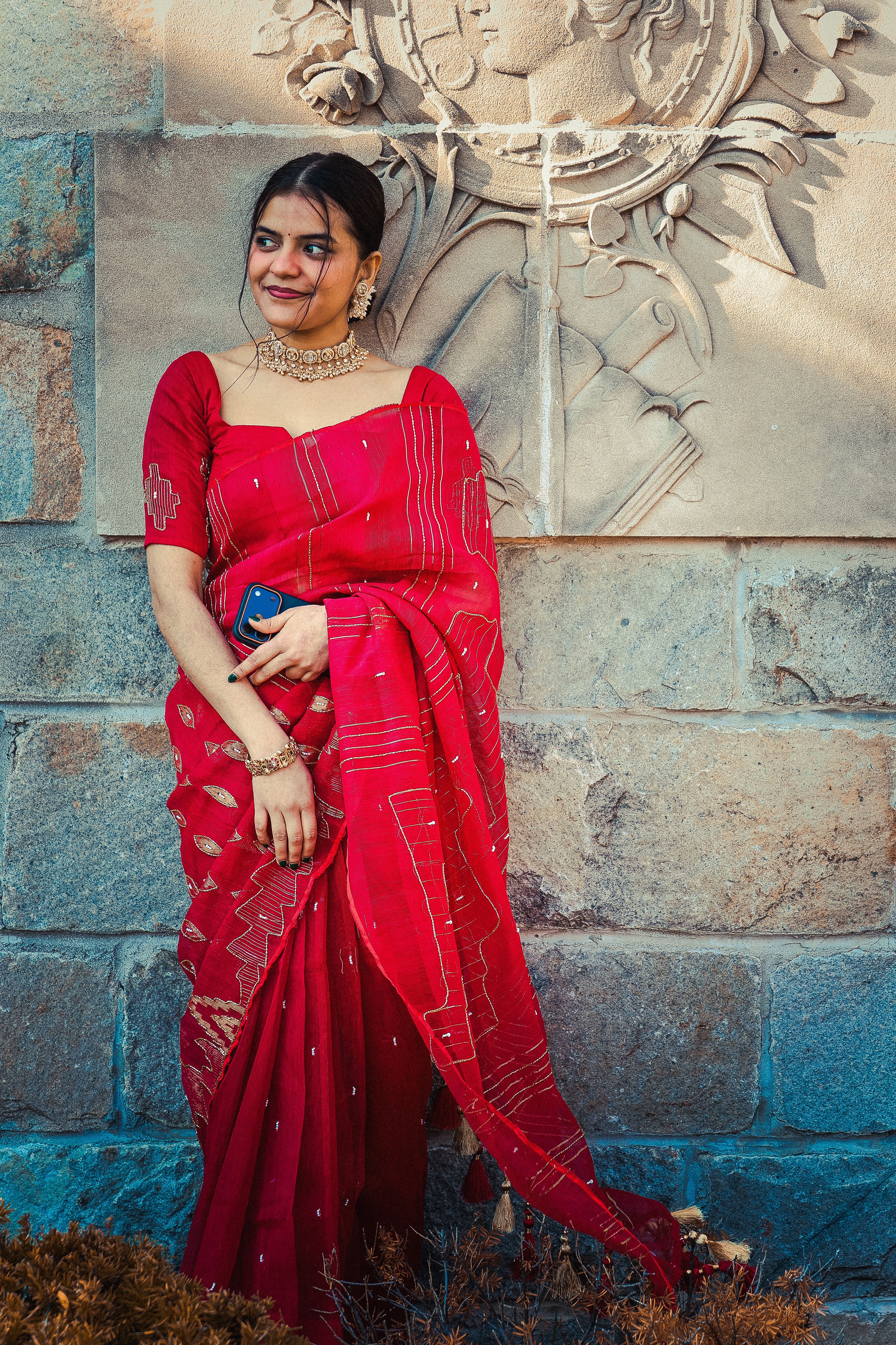4640x6960 Elegant Woman in Red Saree with Stone Relief · Free
