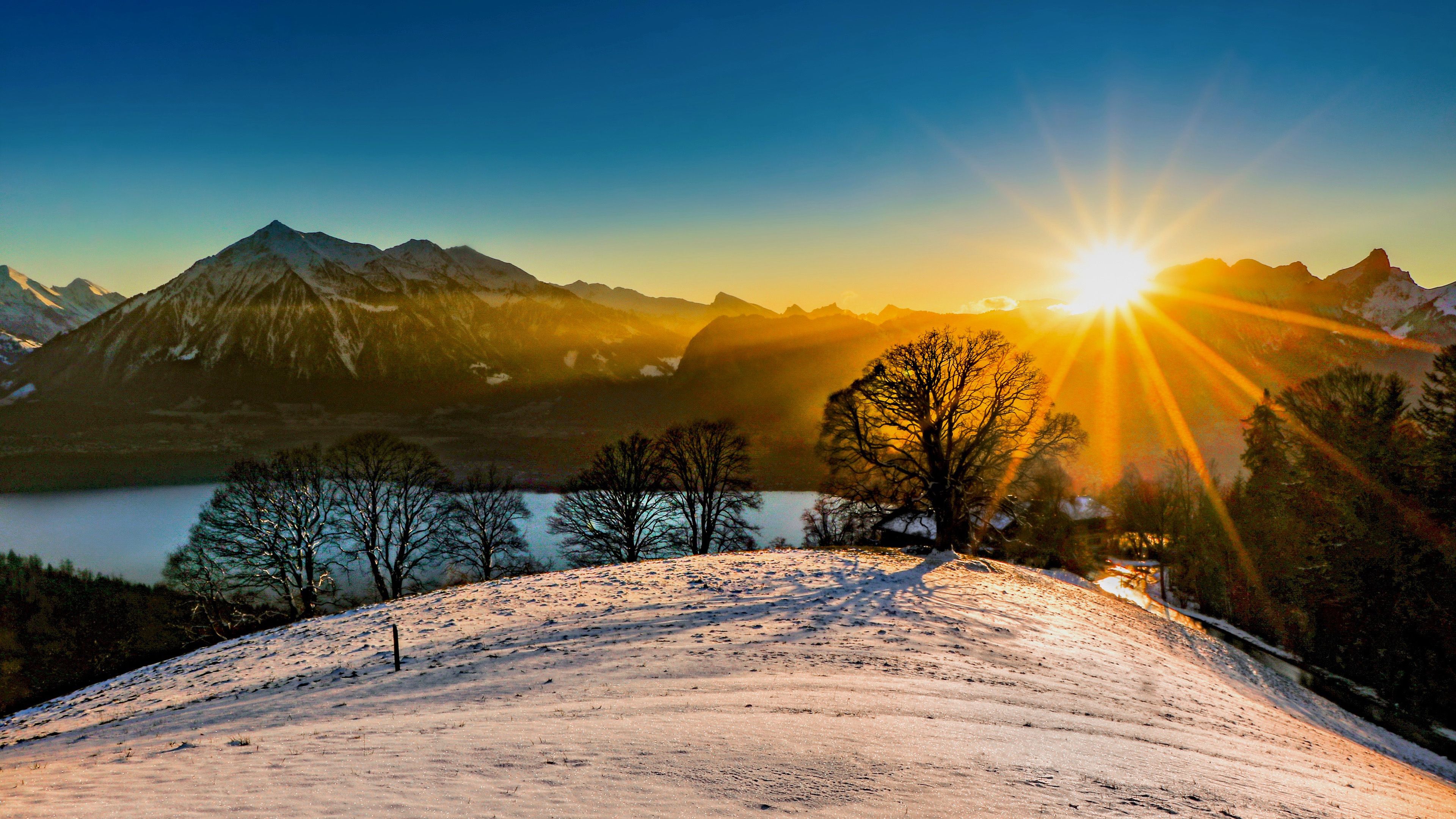 3840x2160 Trees Mountains River In Sunrise Background Under Blue Sky 4K HD Sunrise Wallpaper