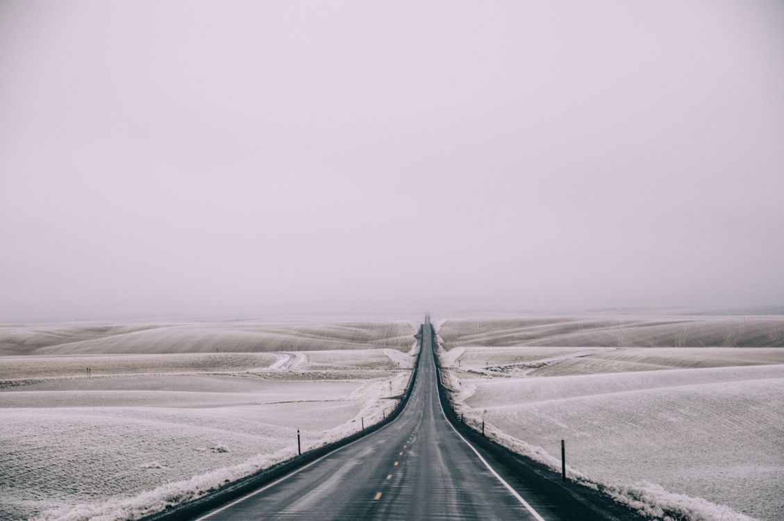 1129x750 Desolate Winter Road In Snow Covered Landscape · Free