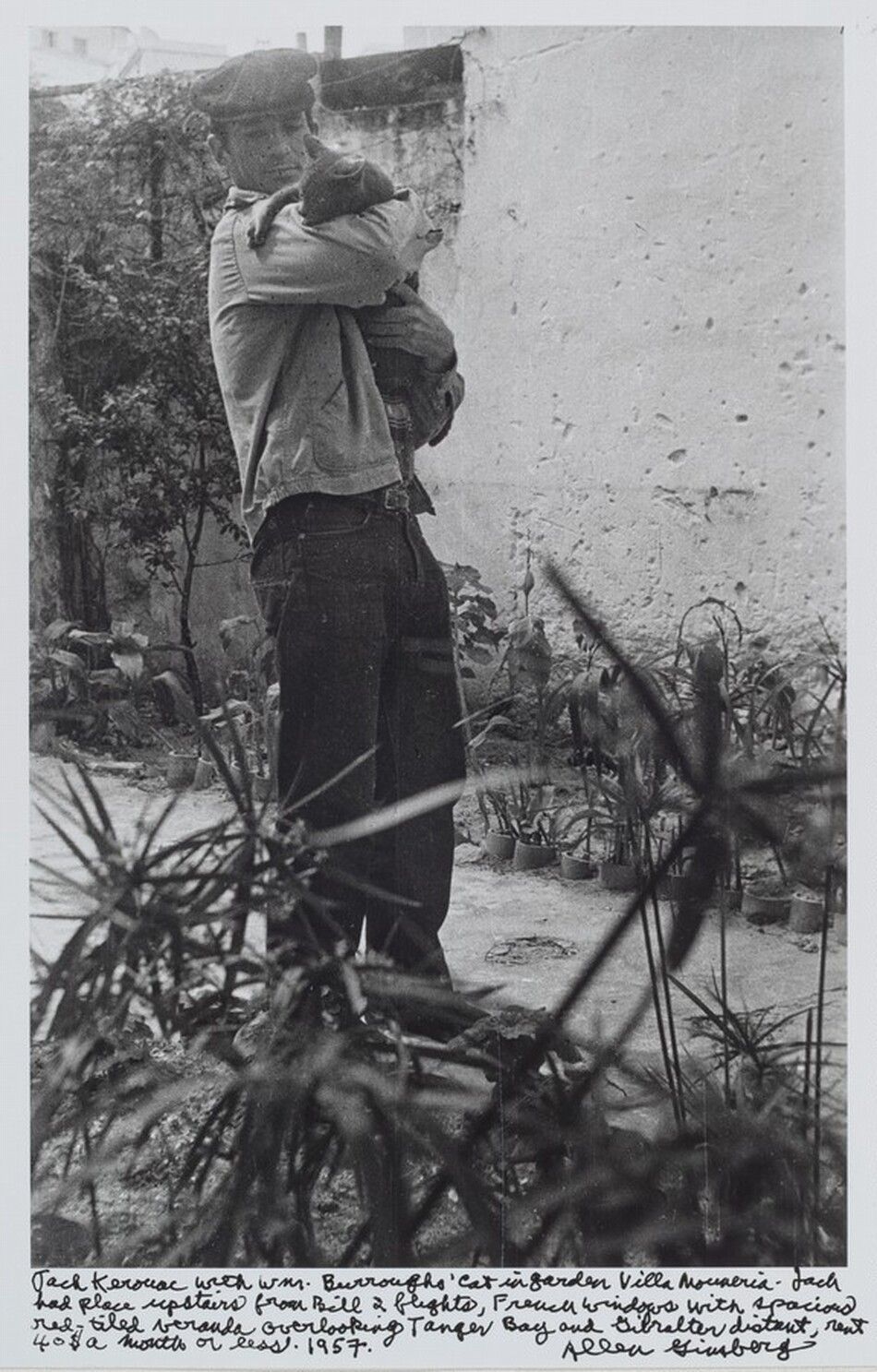 950x1487 Jack Kerouac 1953 Seen through window sill lined with books, from Fire Escape 206 E. 7 St. N.Y.C. He was living or writing Subterraneans