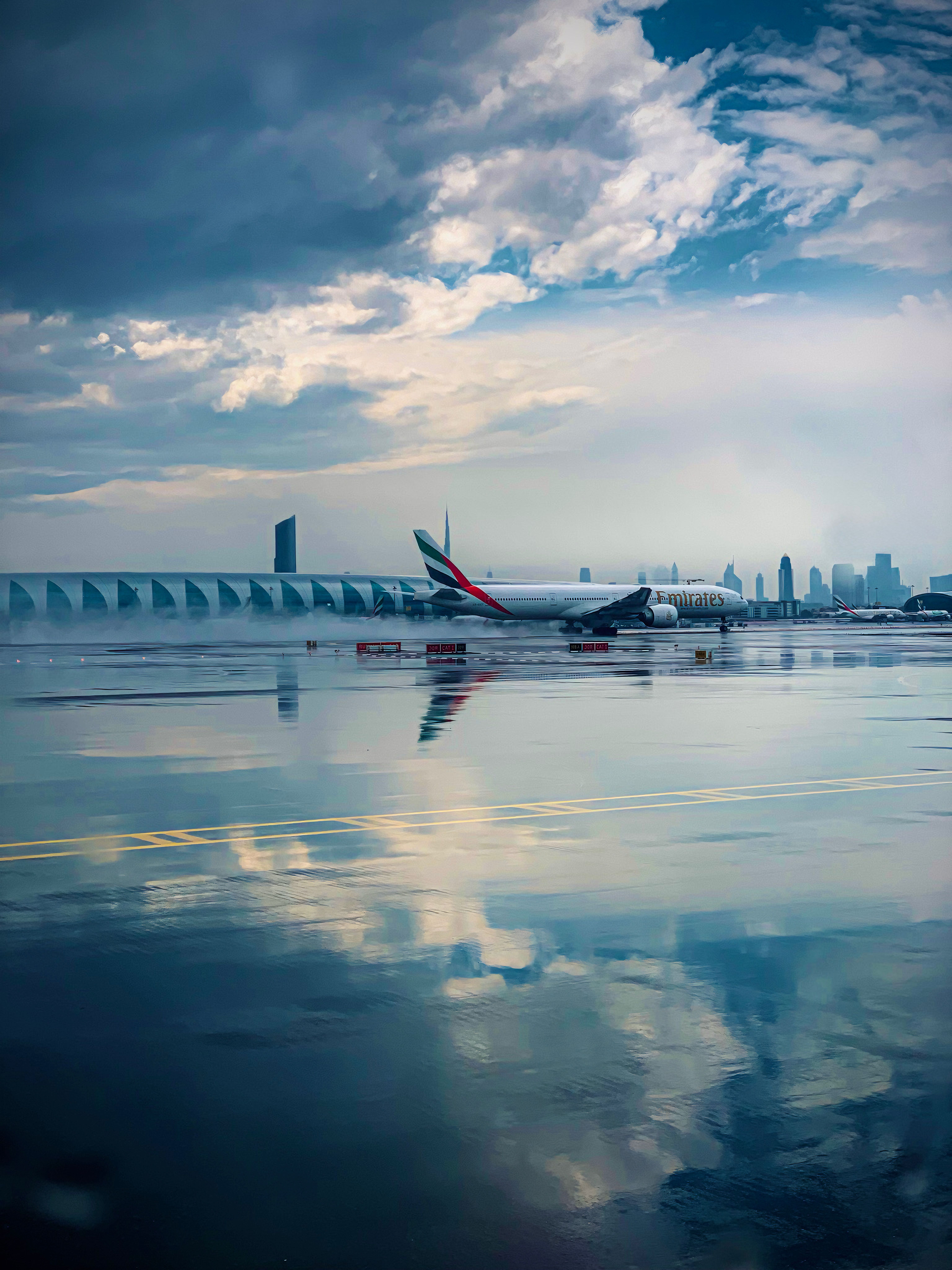 6144x8192 Airplane on Rainy Runway with City Skyline · Free