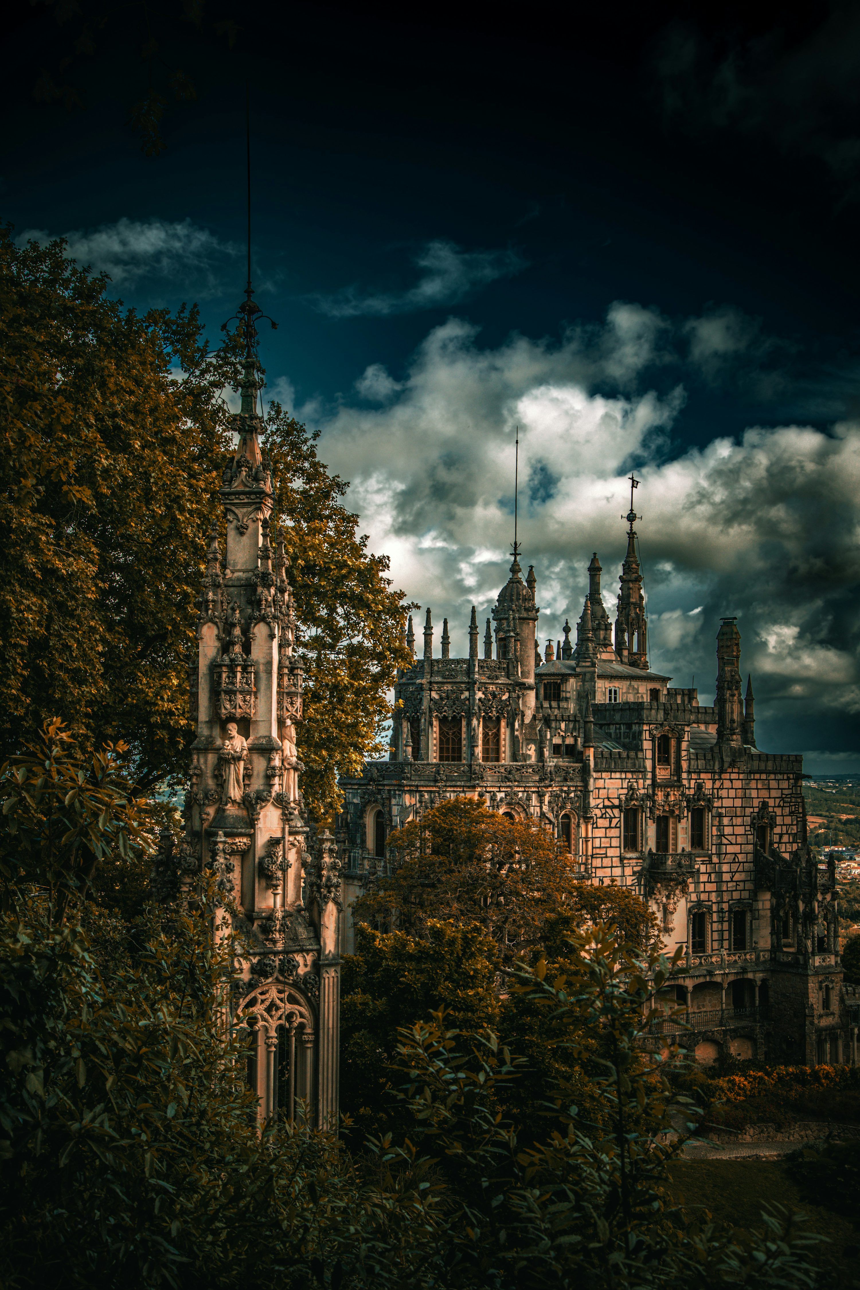 3000x4499 Gothic castle ruins surrounded by trees under cloudy sky