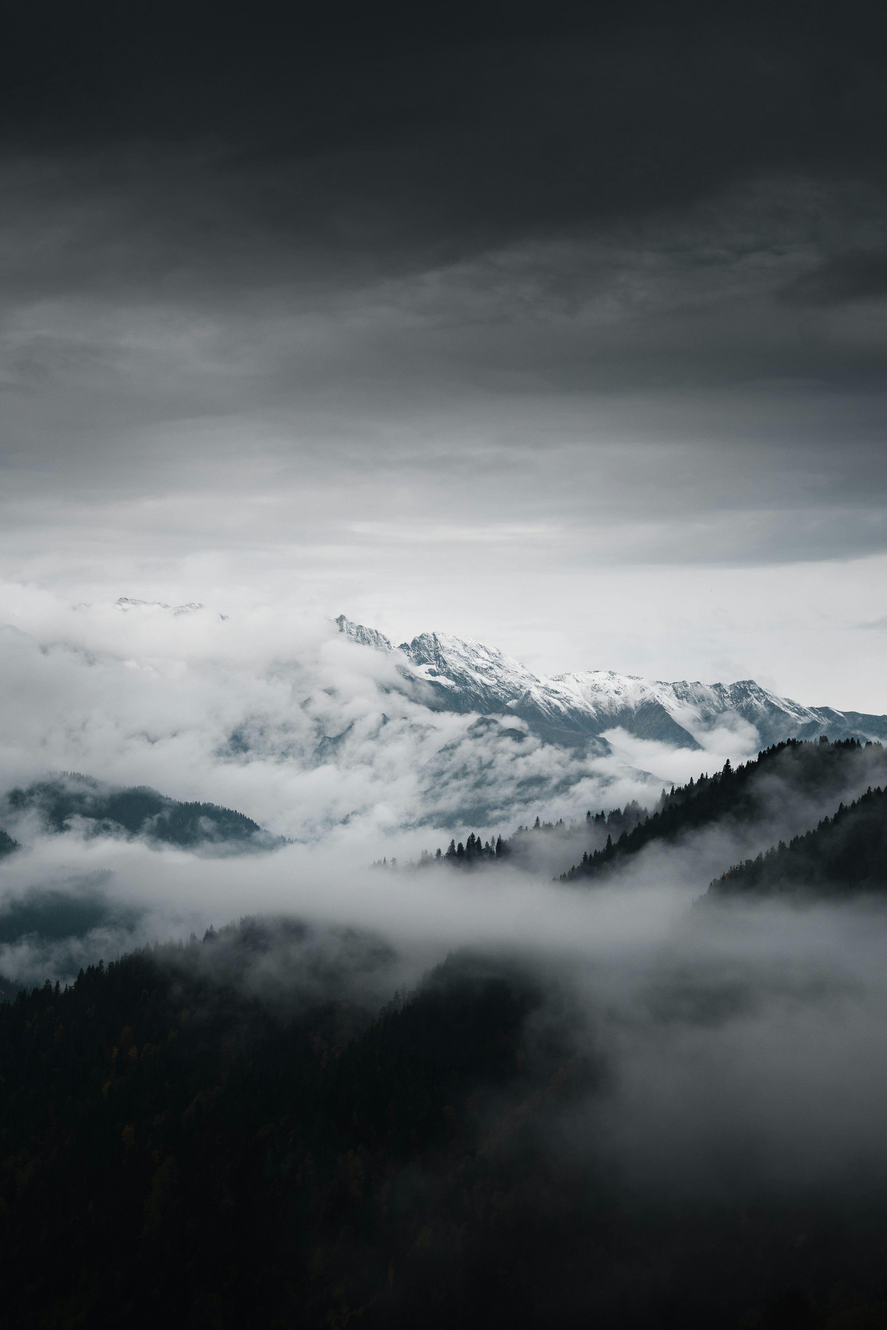 3000x4500 Mountains are shrouded in clouds on a stormy day