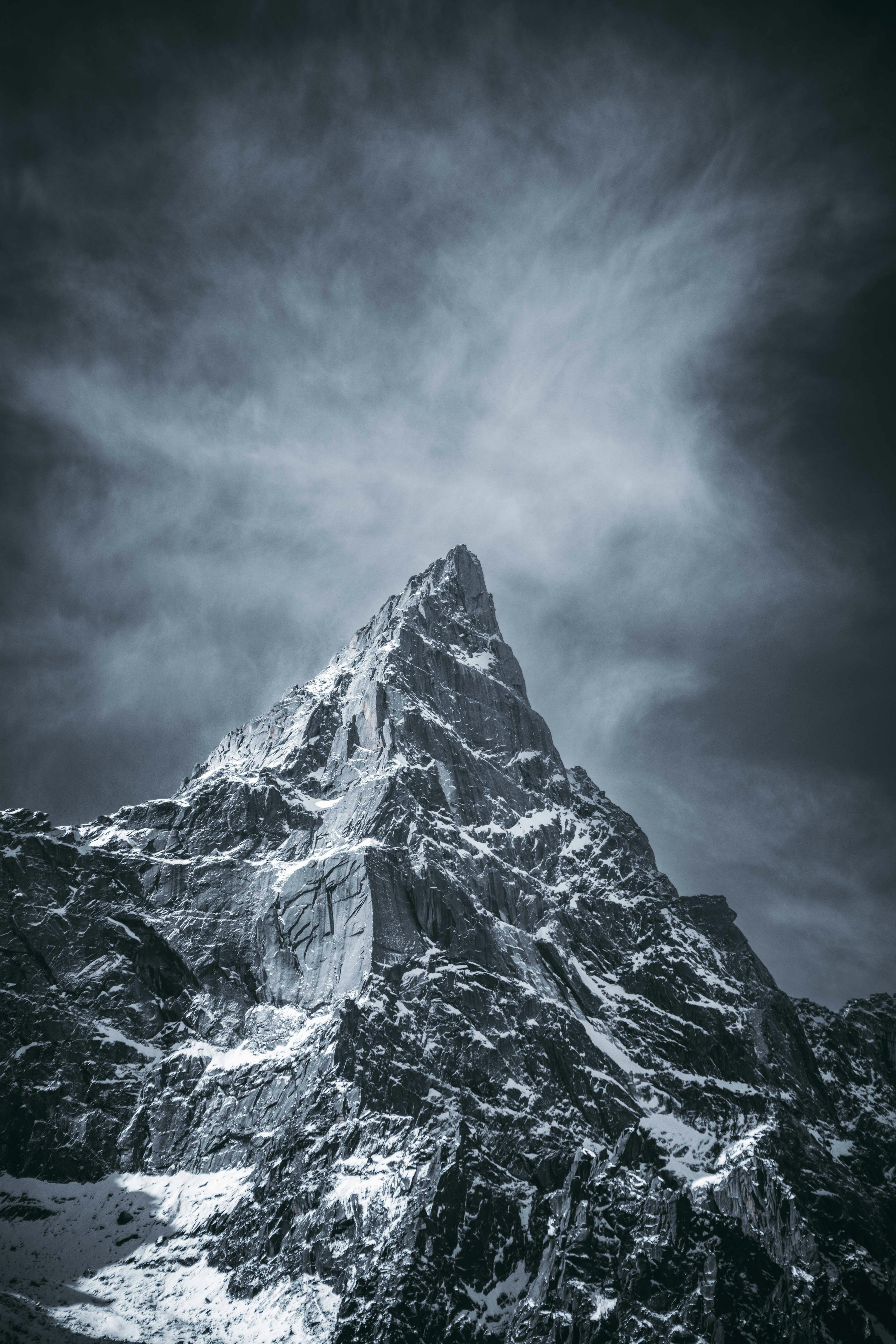 3000x4500 Snowy mountain peak under dramatic stormy sky