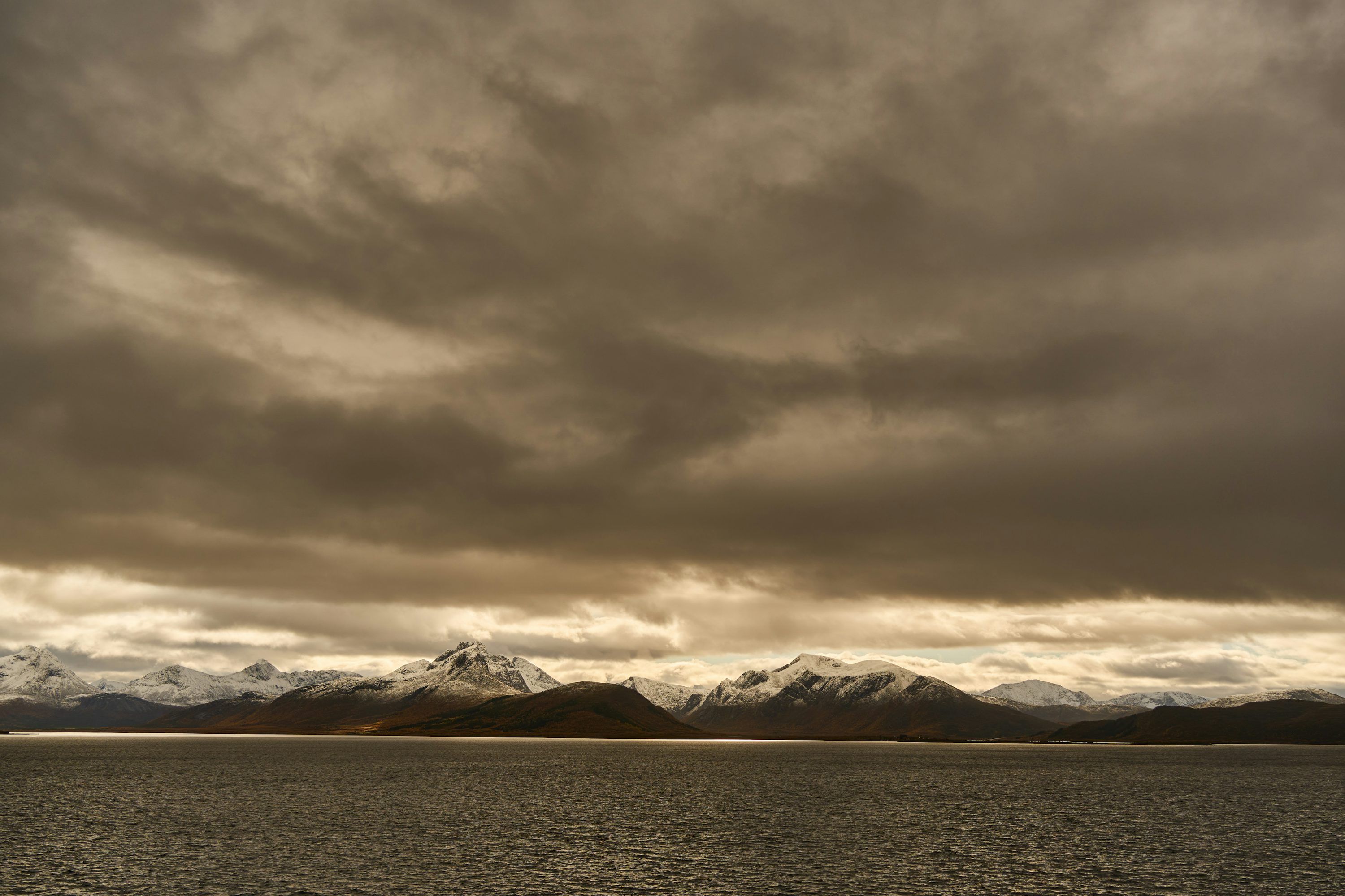 3000x2000 Stormy Clouds Over Snow Capped Mountains And Water