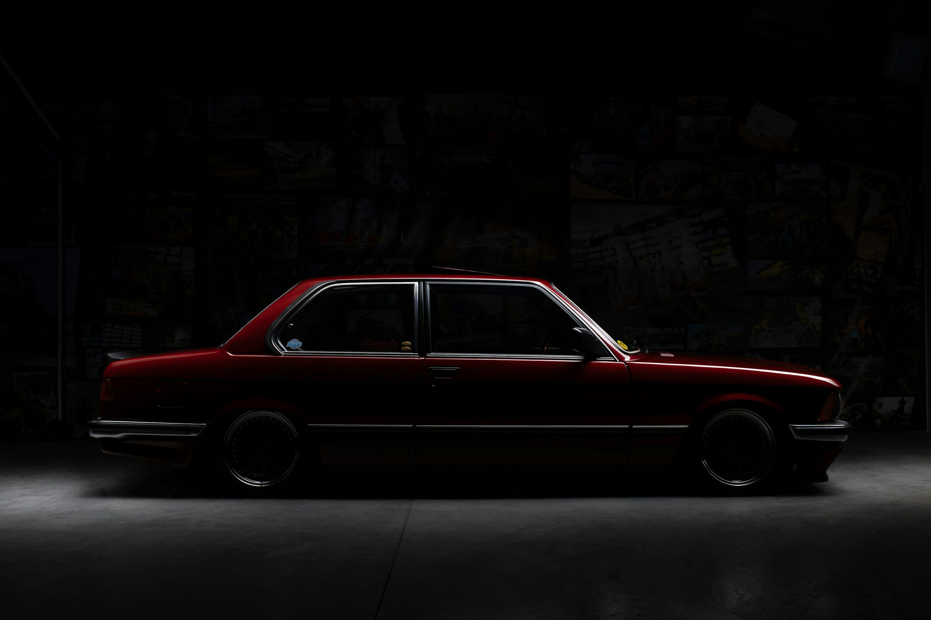3000x2000 A red vintage car parked in a dark room
