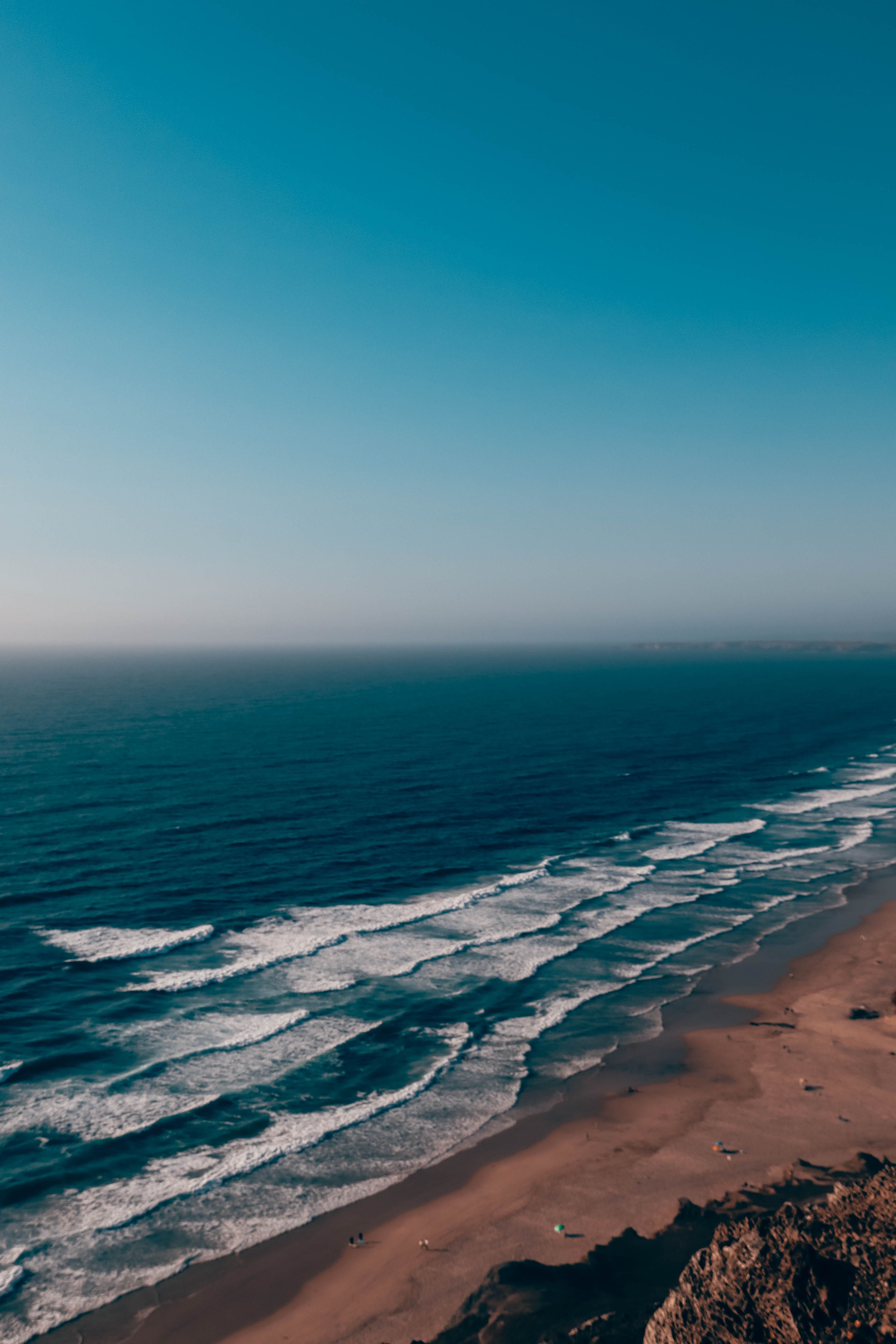 3433x5150 Serene Aerial View of Ocean Waves and Sandy Beach · Free