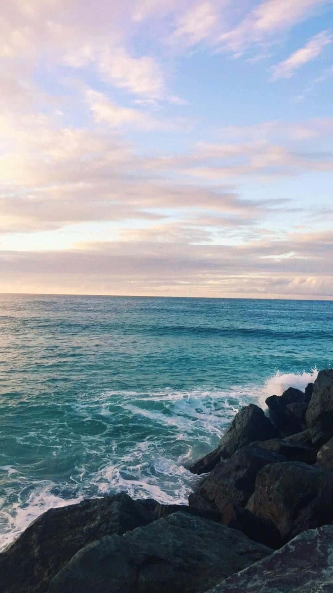 1080x1920 Download Soak up the ocean sunrise in this phone's beautiful aesthetic Wallpaper