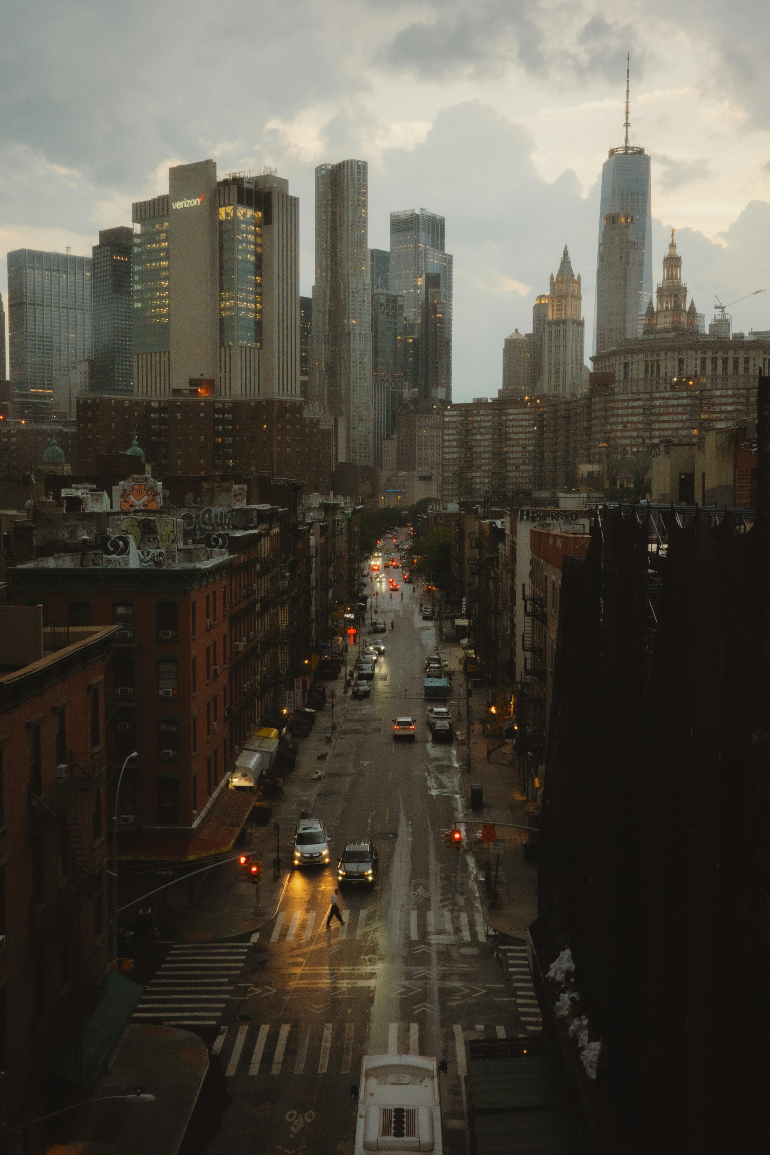 3000x4500 Rainy city street with cars and tall buildings at dusk