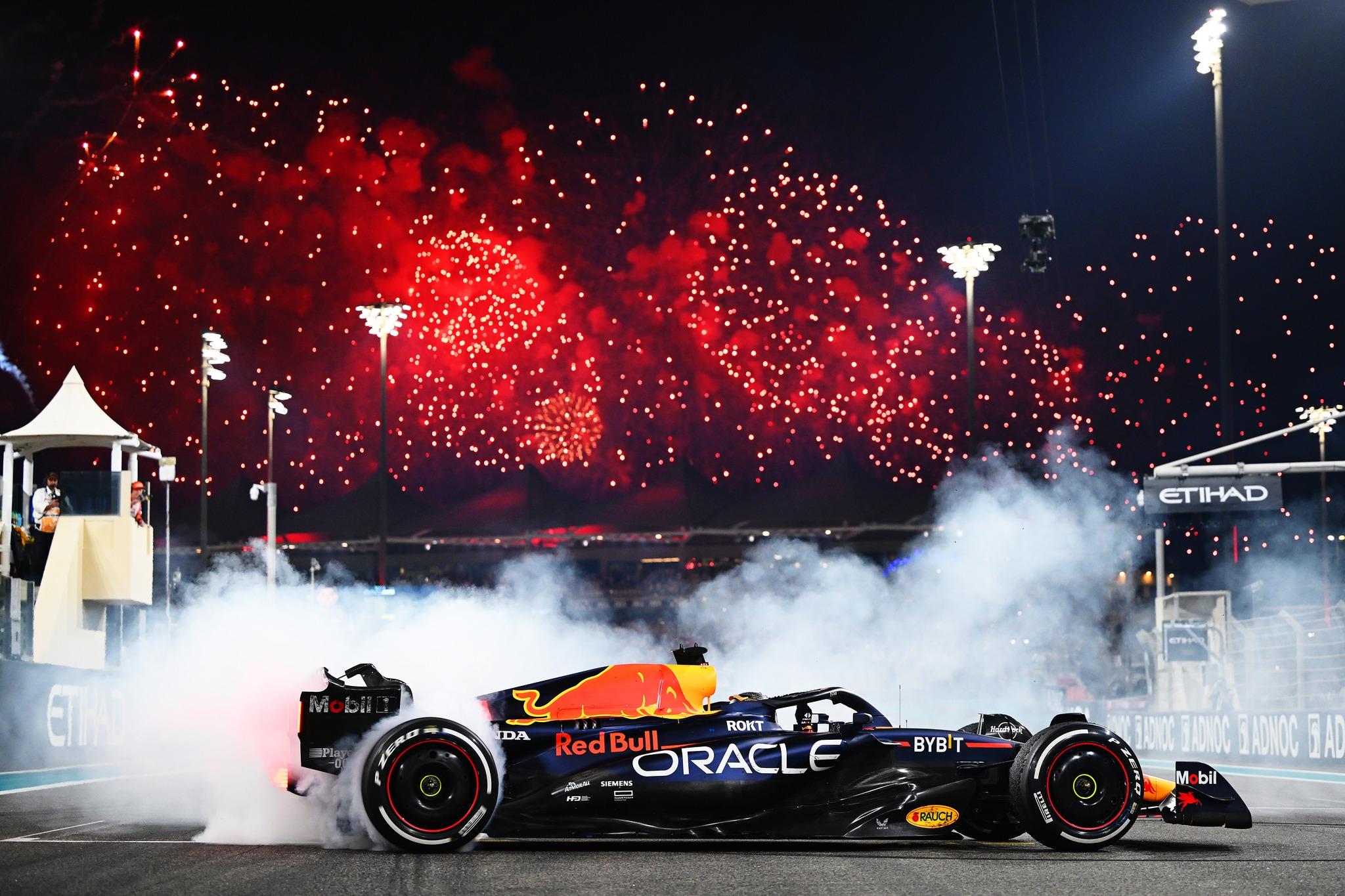 2048x1365 Max Verstappen (Red Bull Racing RB19) doing donuts after the 2023 Abu Dhabi Grand Prix with fireworks going off in the background [2048x1365]
