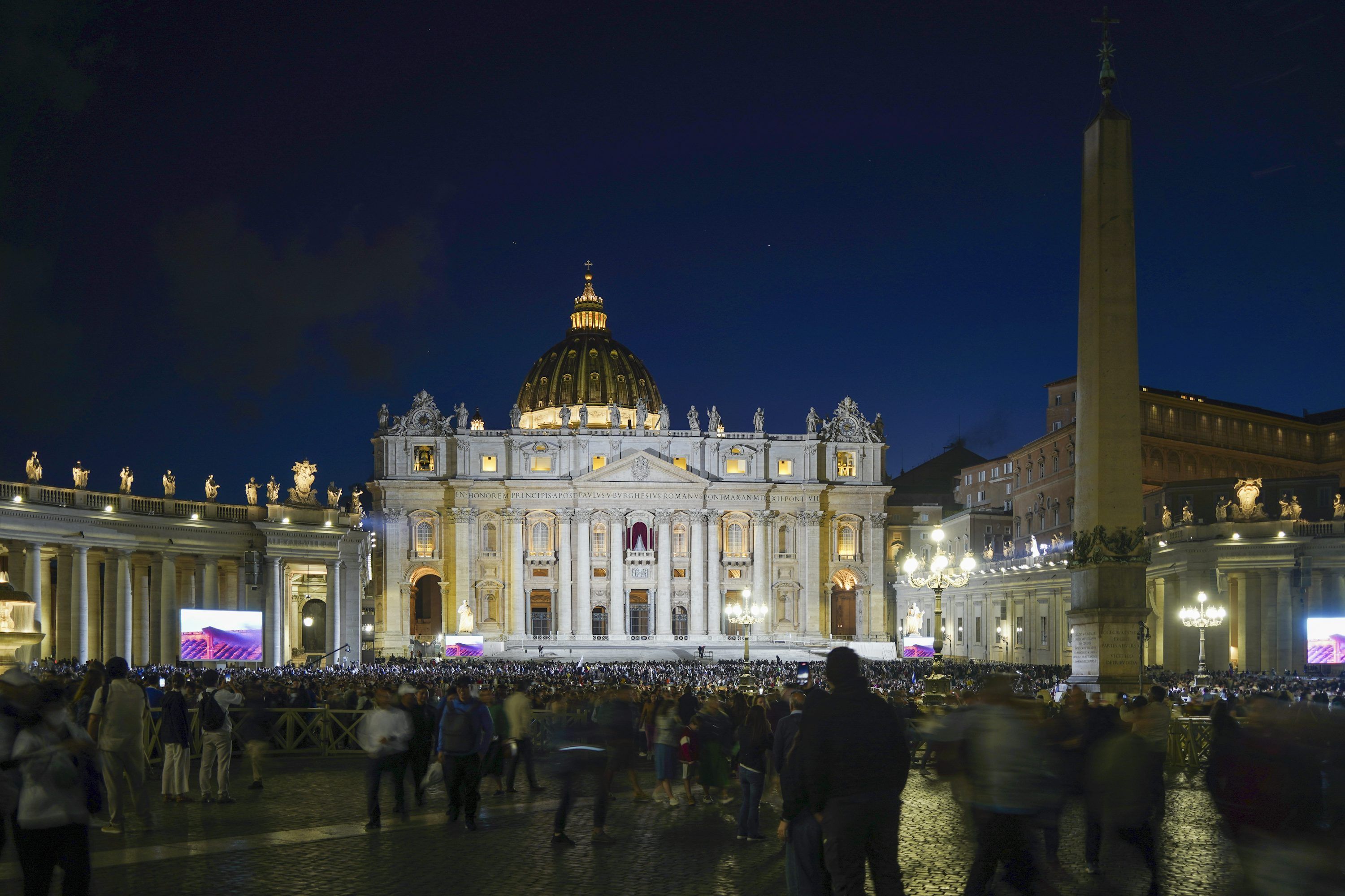 3000x2000 People gather at st. peter's basilica at night