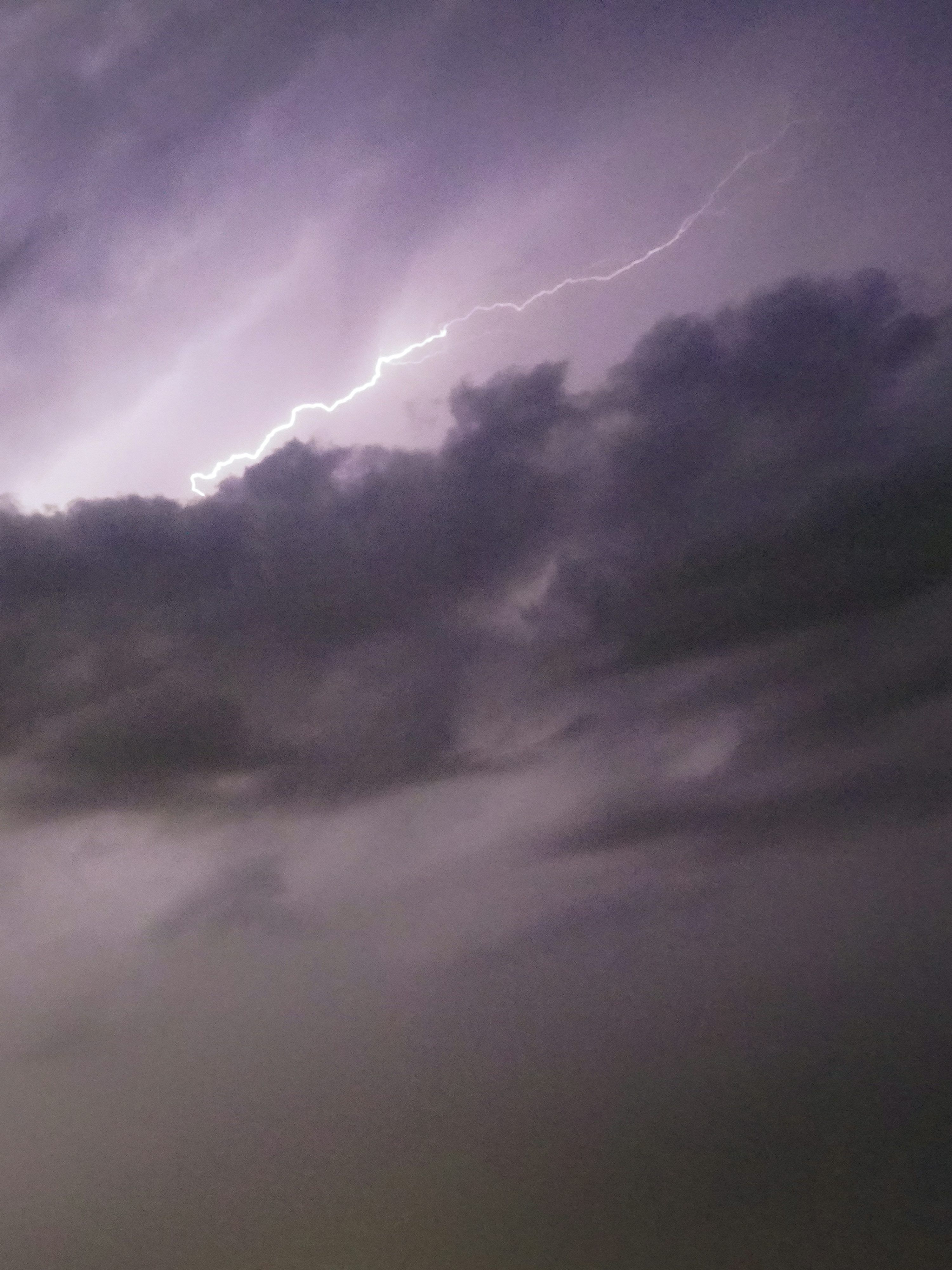 3000x4000 Lightning bolt strikes through dark stormy clouds