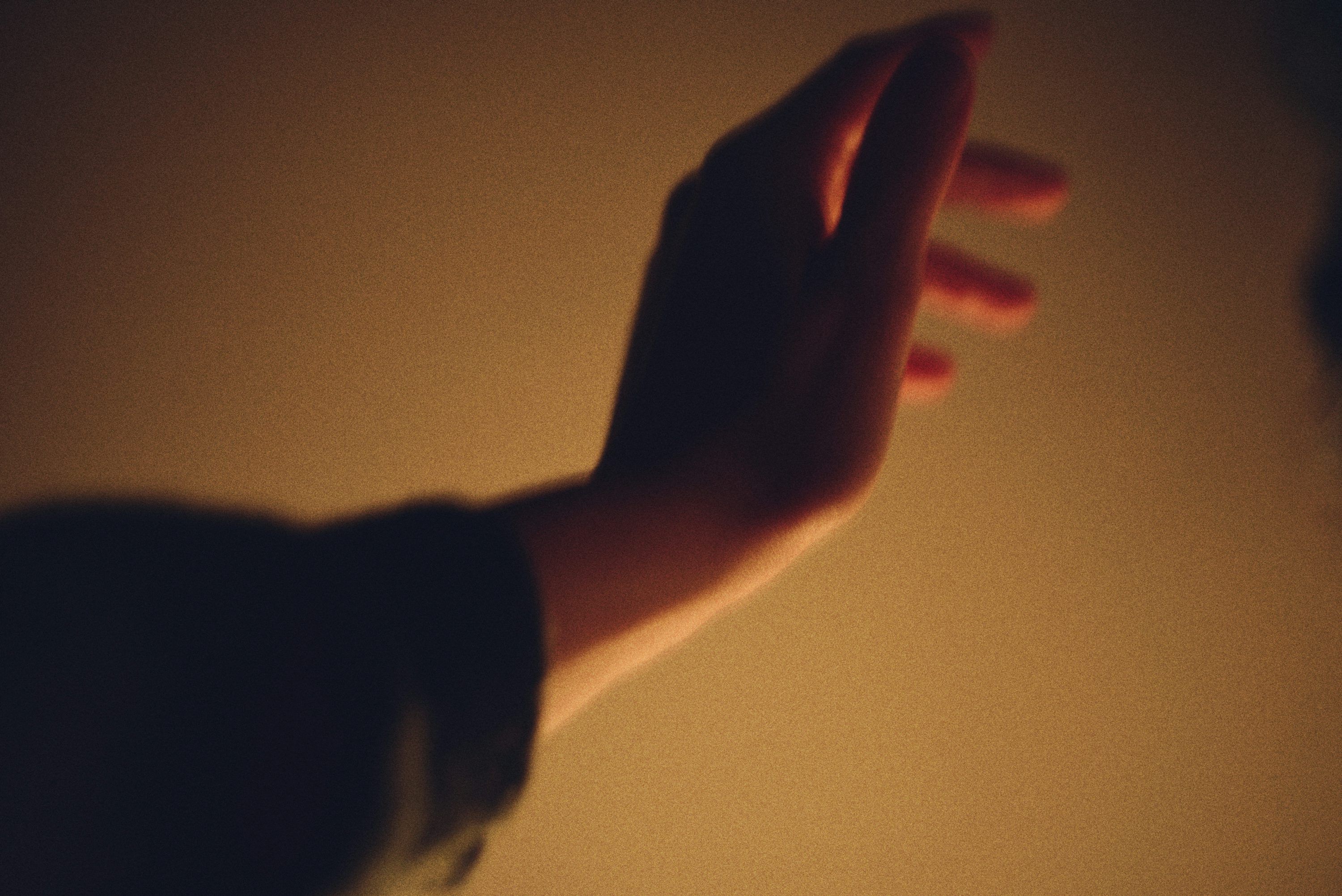 3000x2003 A hand reaching out in warm light