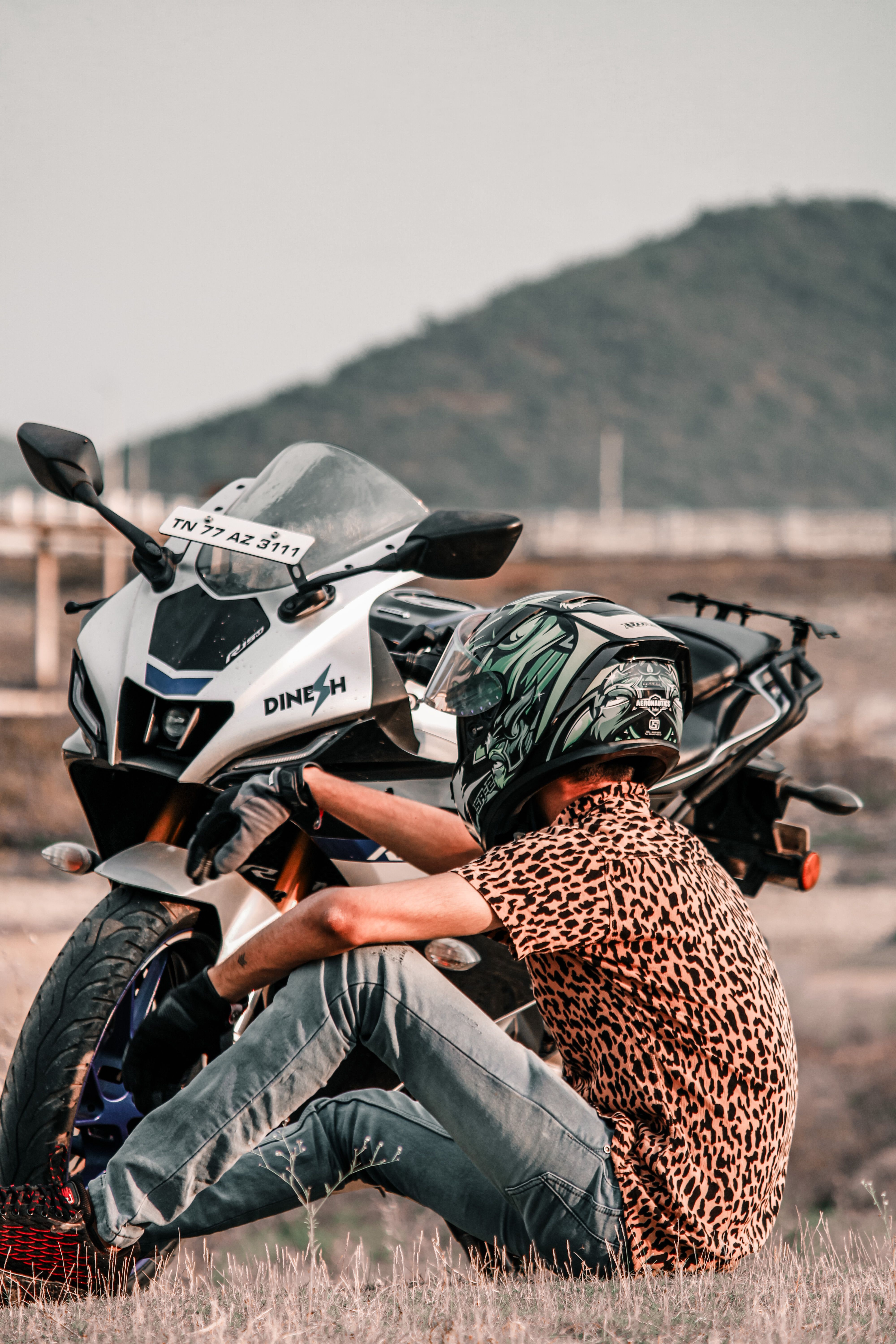 4000x6000 Man in Helmet Sitting with Motorcycle on Field · Free