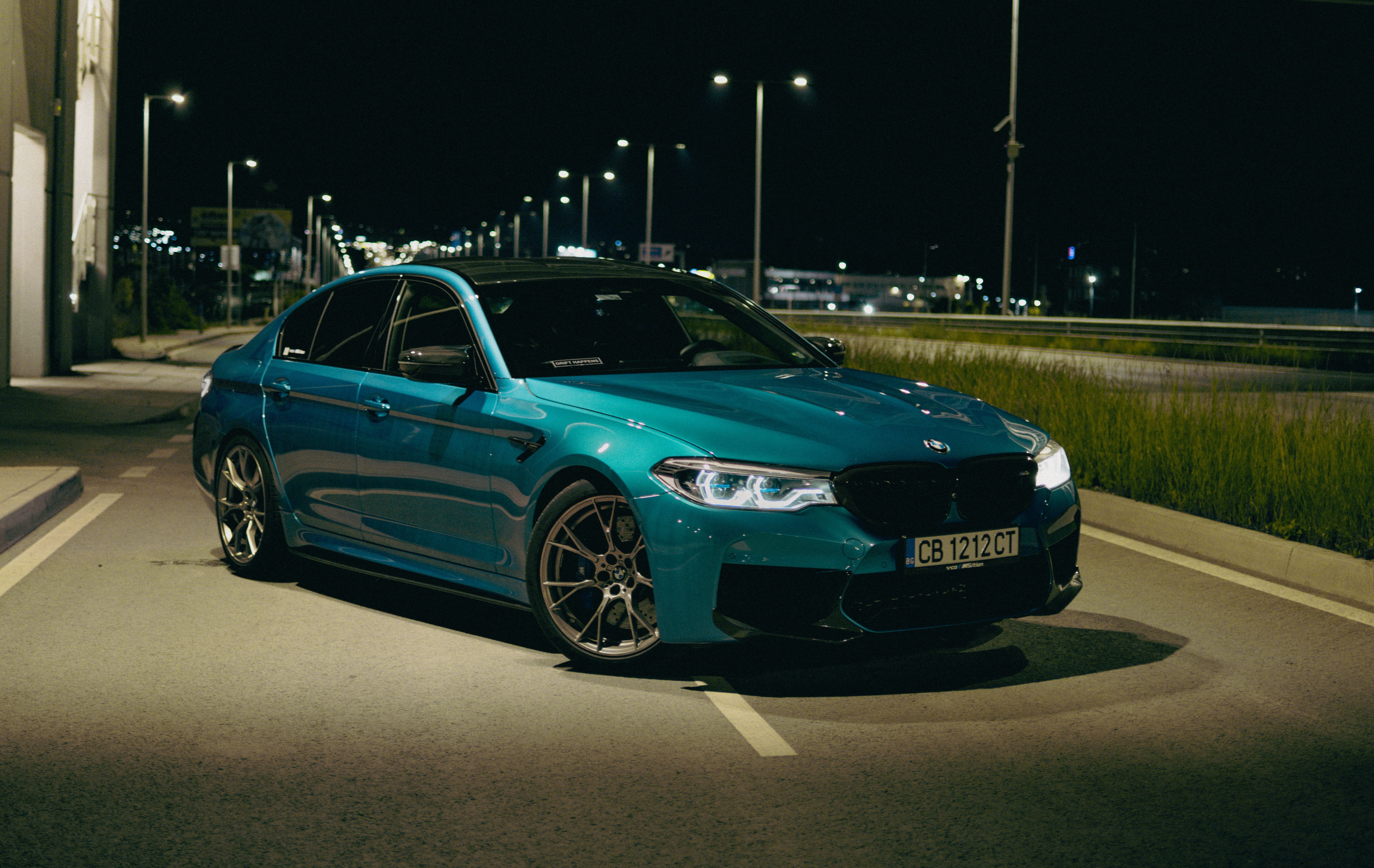 5568x3519 A Blue BMW M5 Parked on a Street at Night · Free